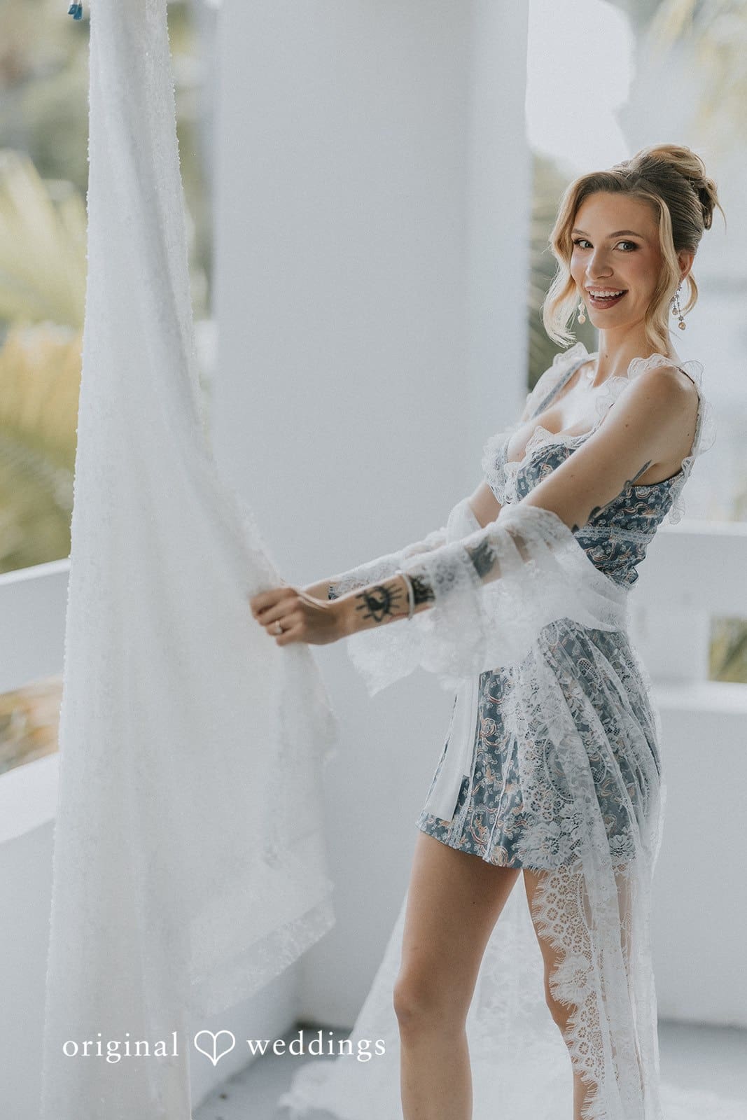 Sabrina + Ryan Bride is looking at the dress with very happy face.