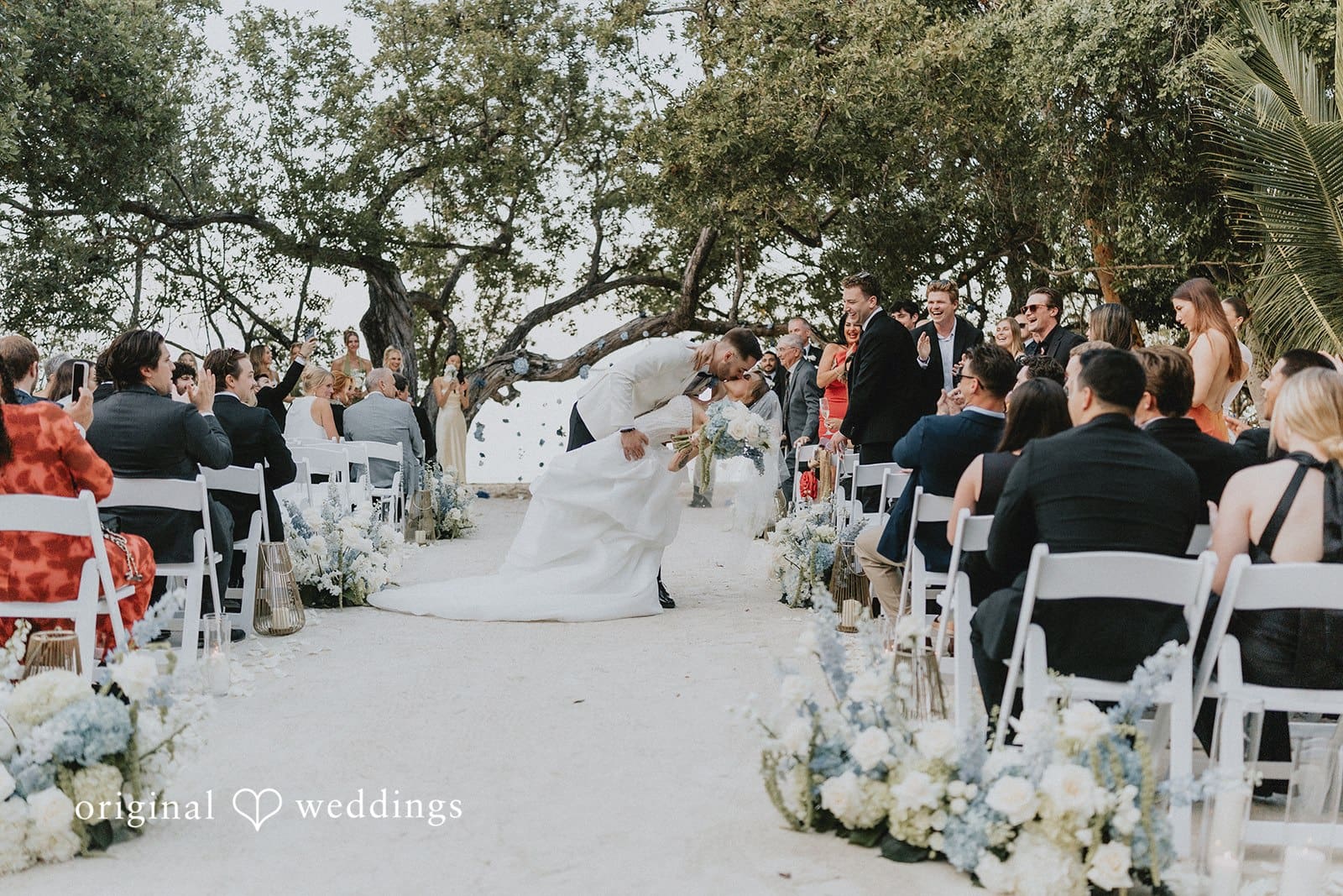 Sabrina + Ryan Couple Kissing each other infront of guests.