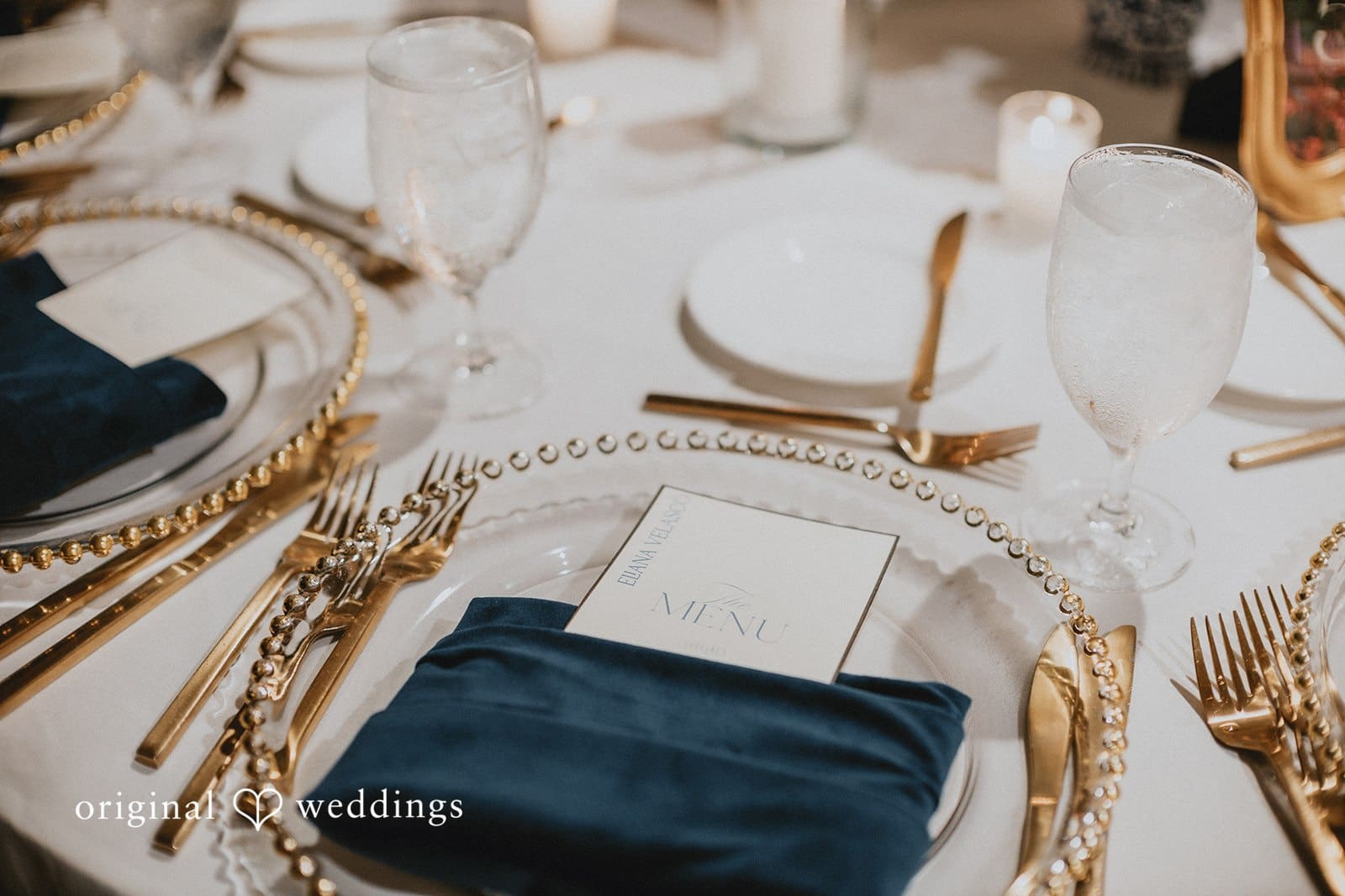 Sabrina + Ryan Decorated wedding table with plates and glassware.