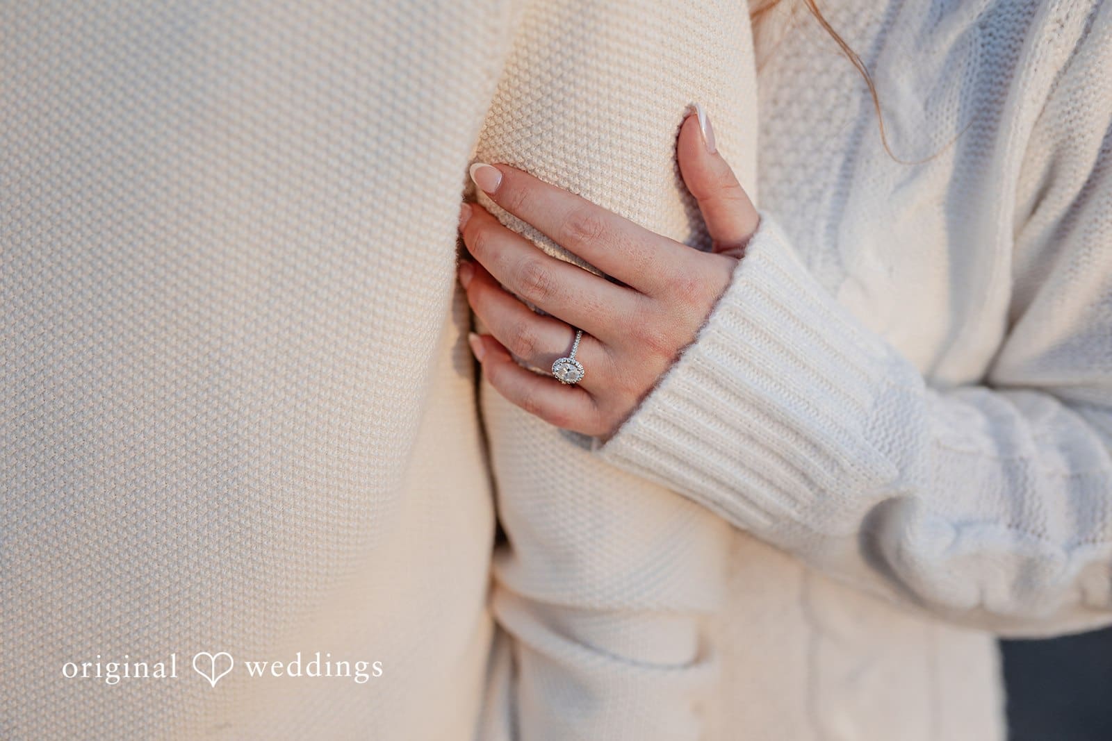 Rosemary + James A close-up shot of the bride holding the groom while her engagement ring shows off