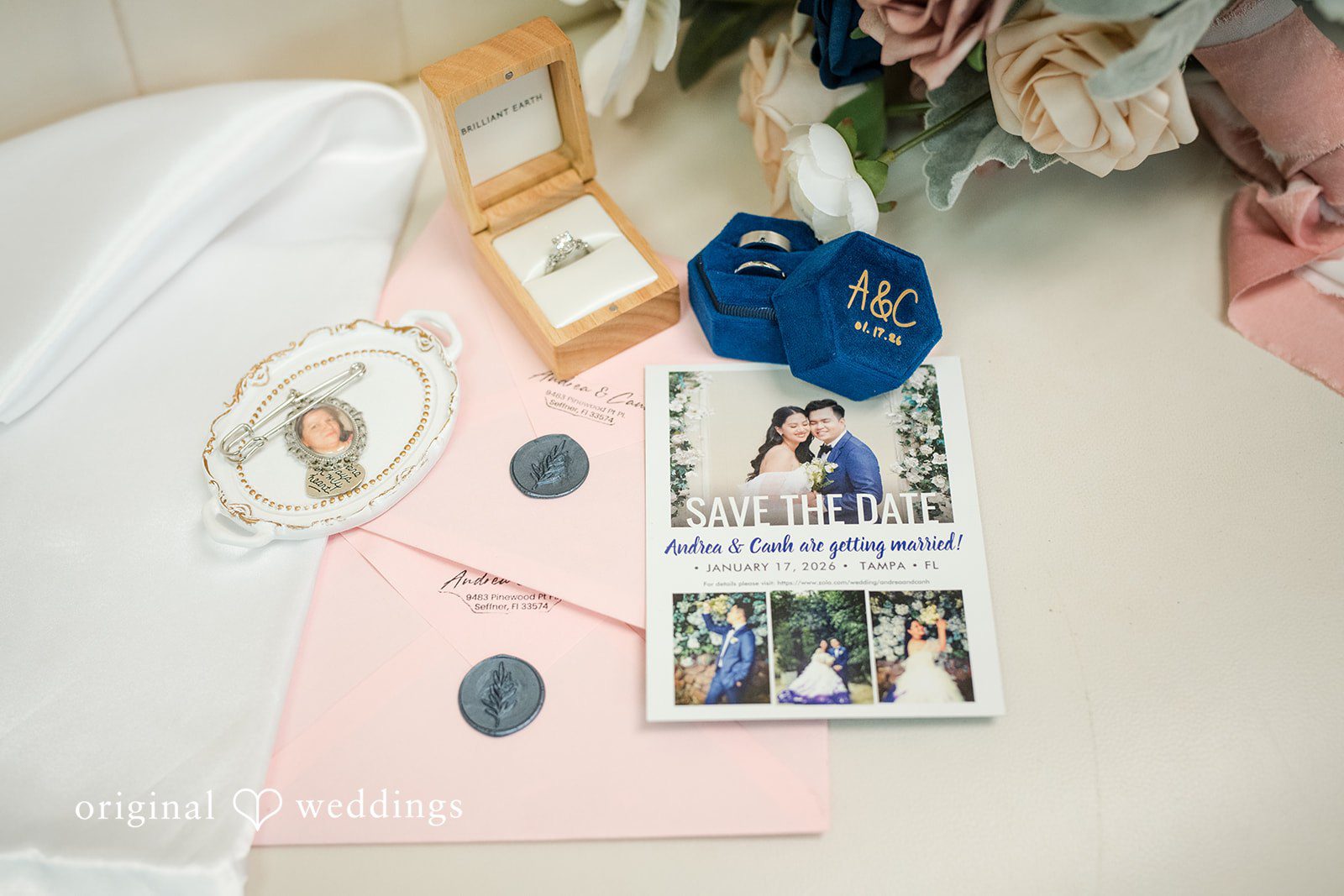 Andrea Edna + Canh Wedding rings and flowers flat lay.