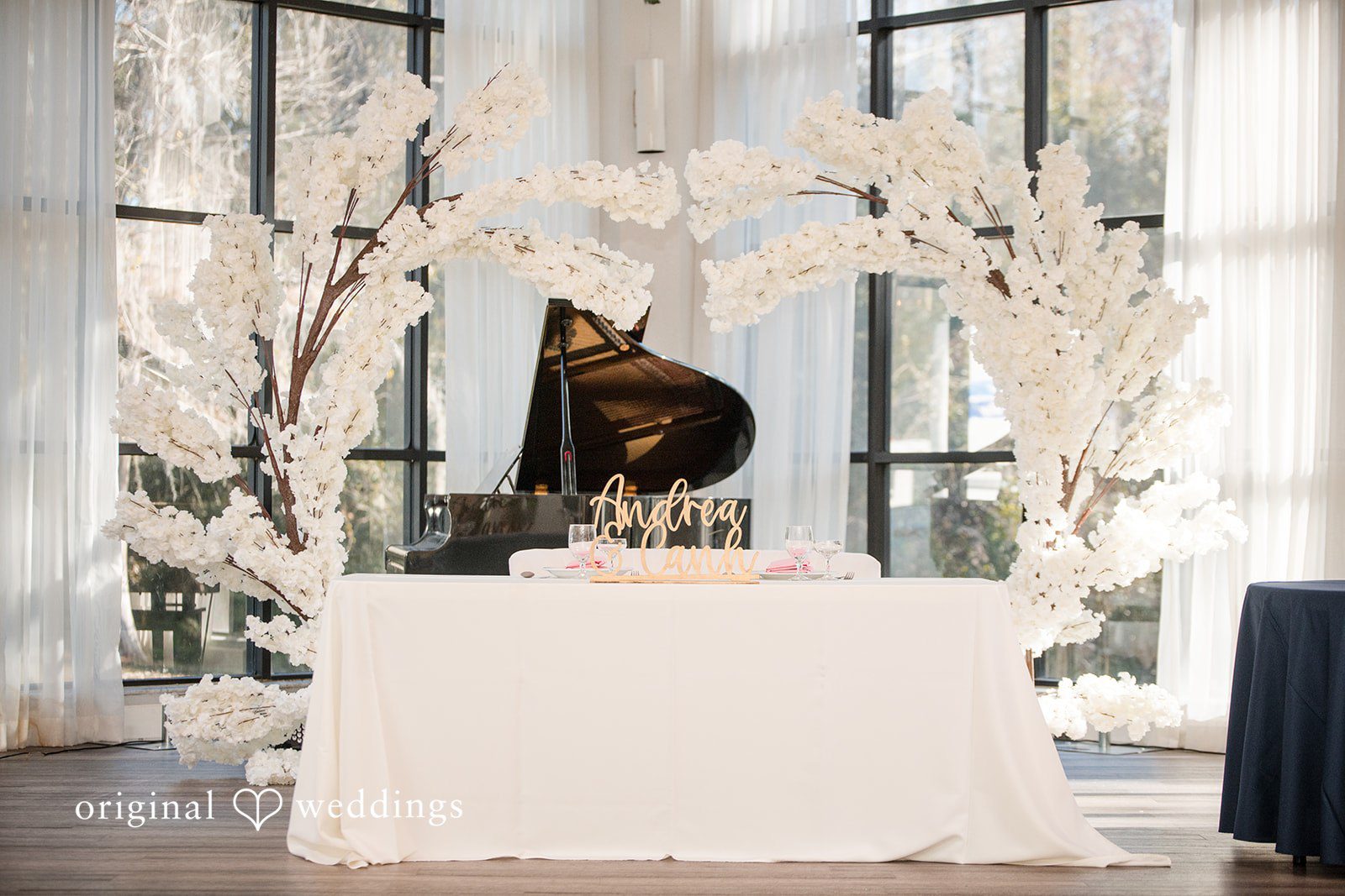 Andrea Edna + Canh Wedding ceremony setup with piano and flowers.