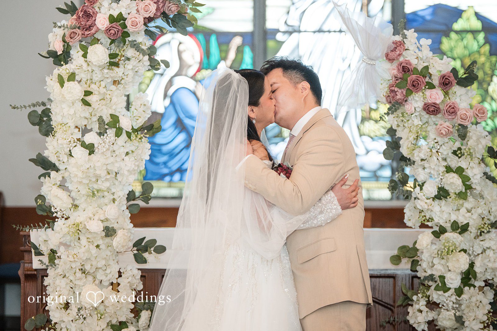 Andrea Edna + Canh Bride and groom sharing a kiss.