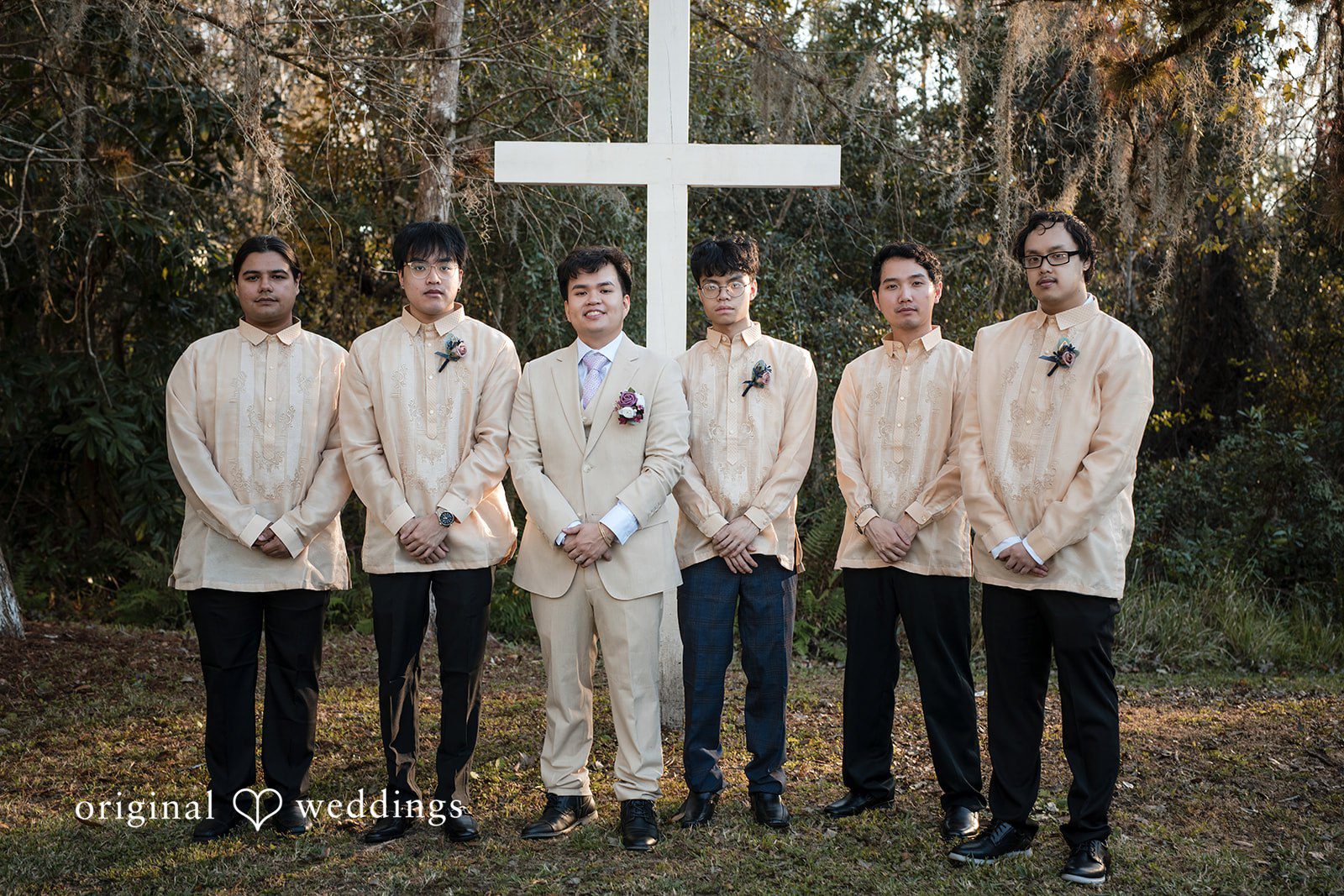 Andrea Edna + Canh Groomsmen posing outdoors.