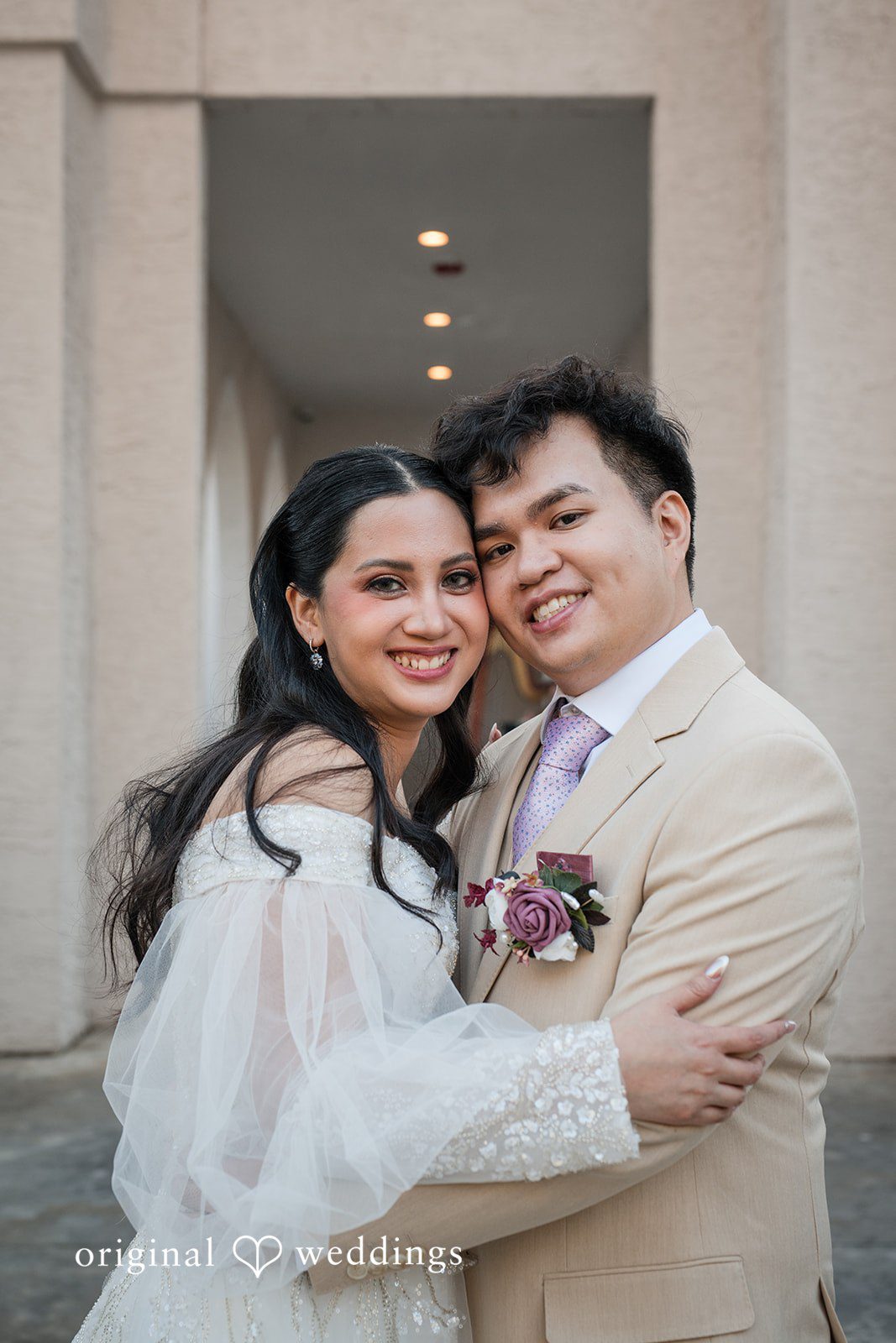 Andrea Edna + Canh Bride and groom hugging in wedding attire at Canterbury Hall Tampa.