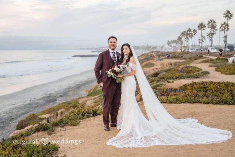 Our San Diego wedding photographer at Original Weddings captured a stunning portrait of the couple at the waterfront near the Carlsbad Windmill