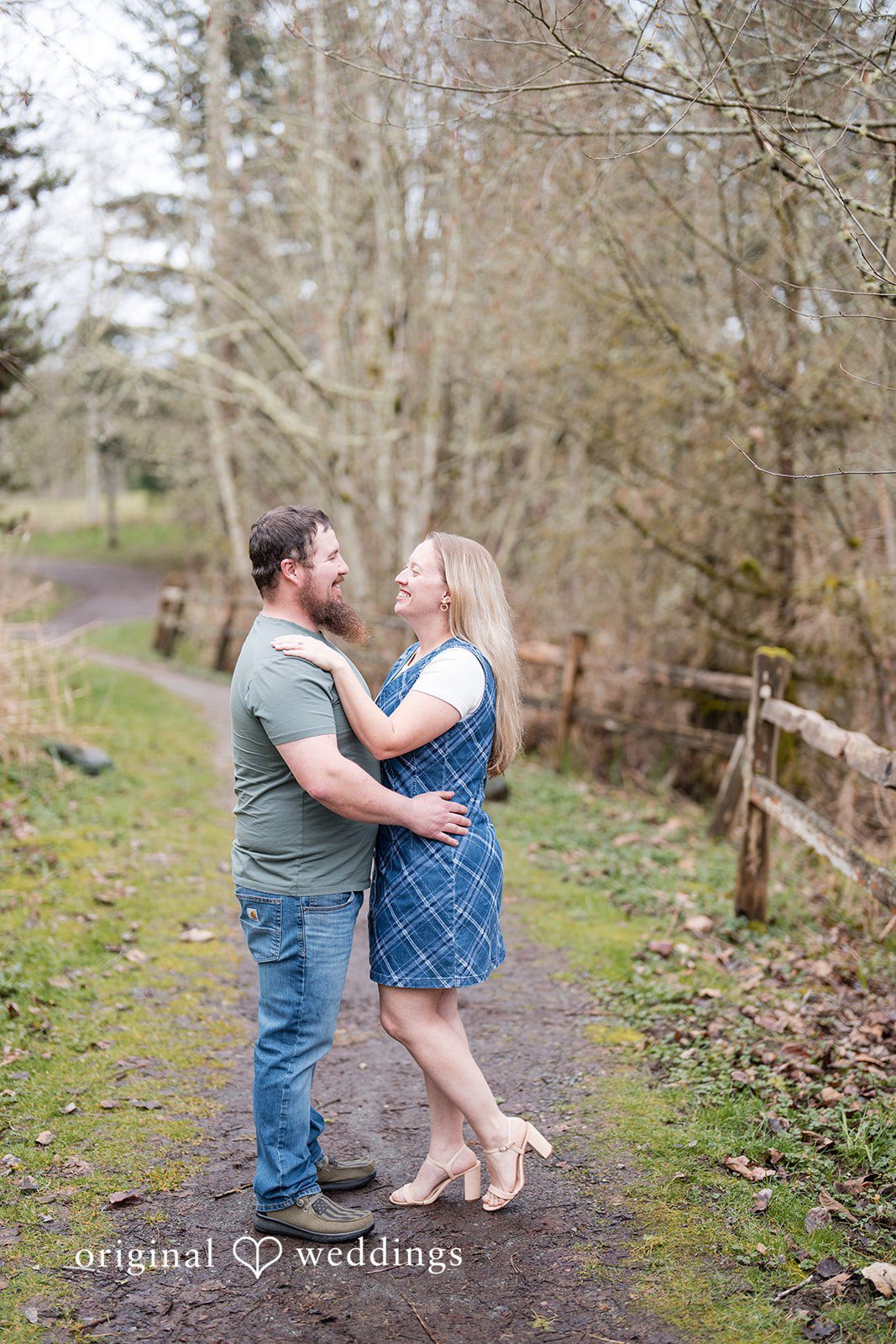 Kayla + Dillon Loving couple looking at each other with soft smiles at Clark Lake Park