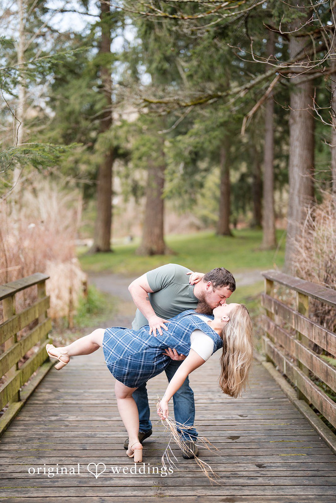 Kayla + Dillon Close-up of groom kissing bride while holding her at Clark Lake Park