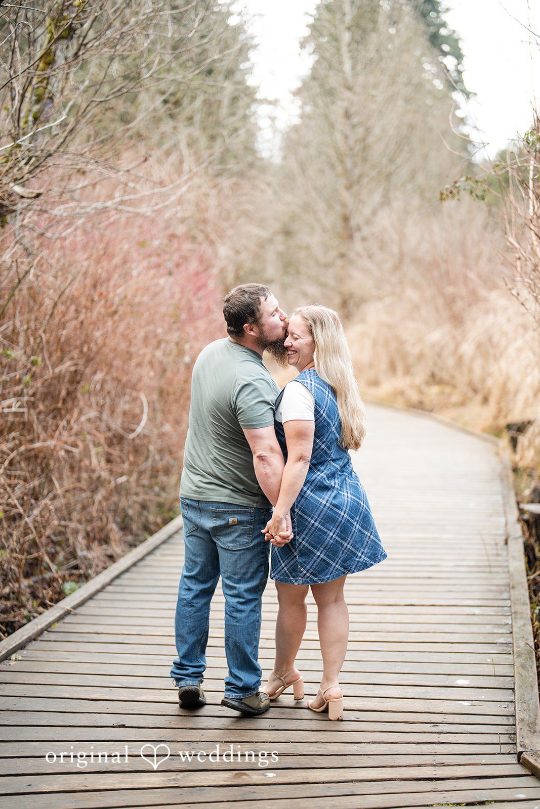 Kayla + Dillon Close-up of groom kissing bride’s forehead at Clark Lake Park
