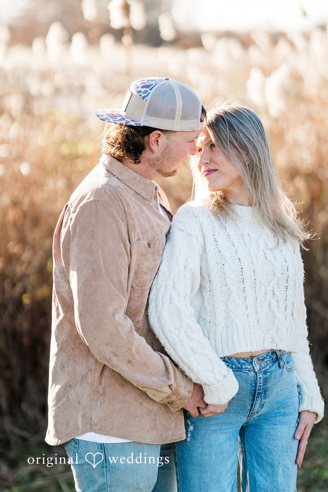 A romantic portrait of the couple at the field