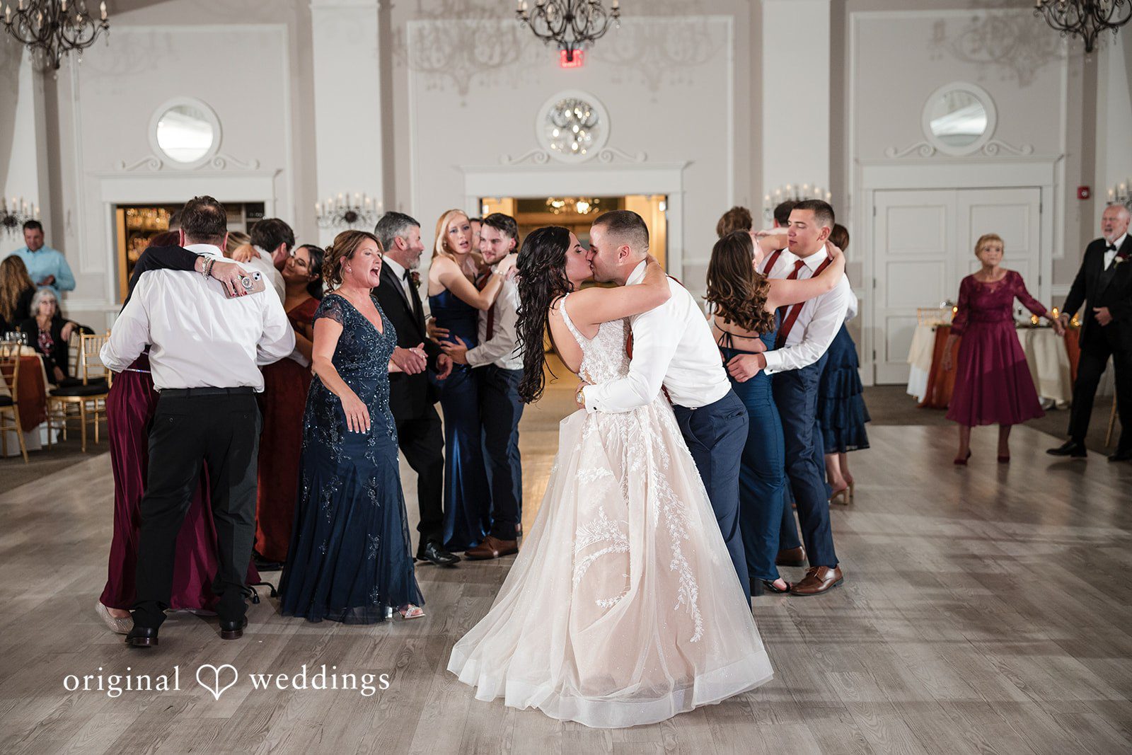 The couple shares a kiss at their wedding reception