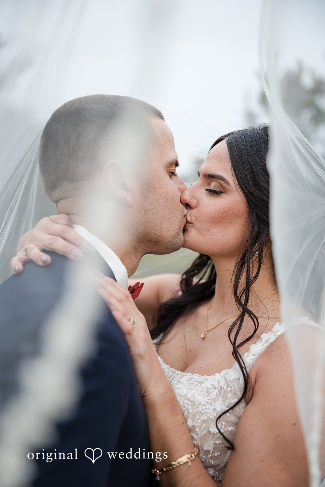 The bride and groom shares a romantic kiss