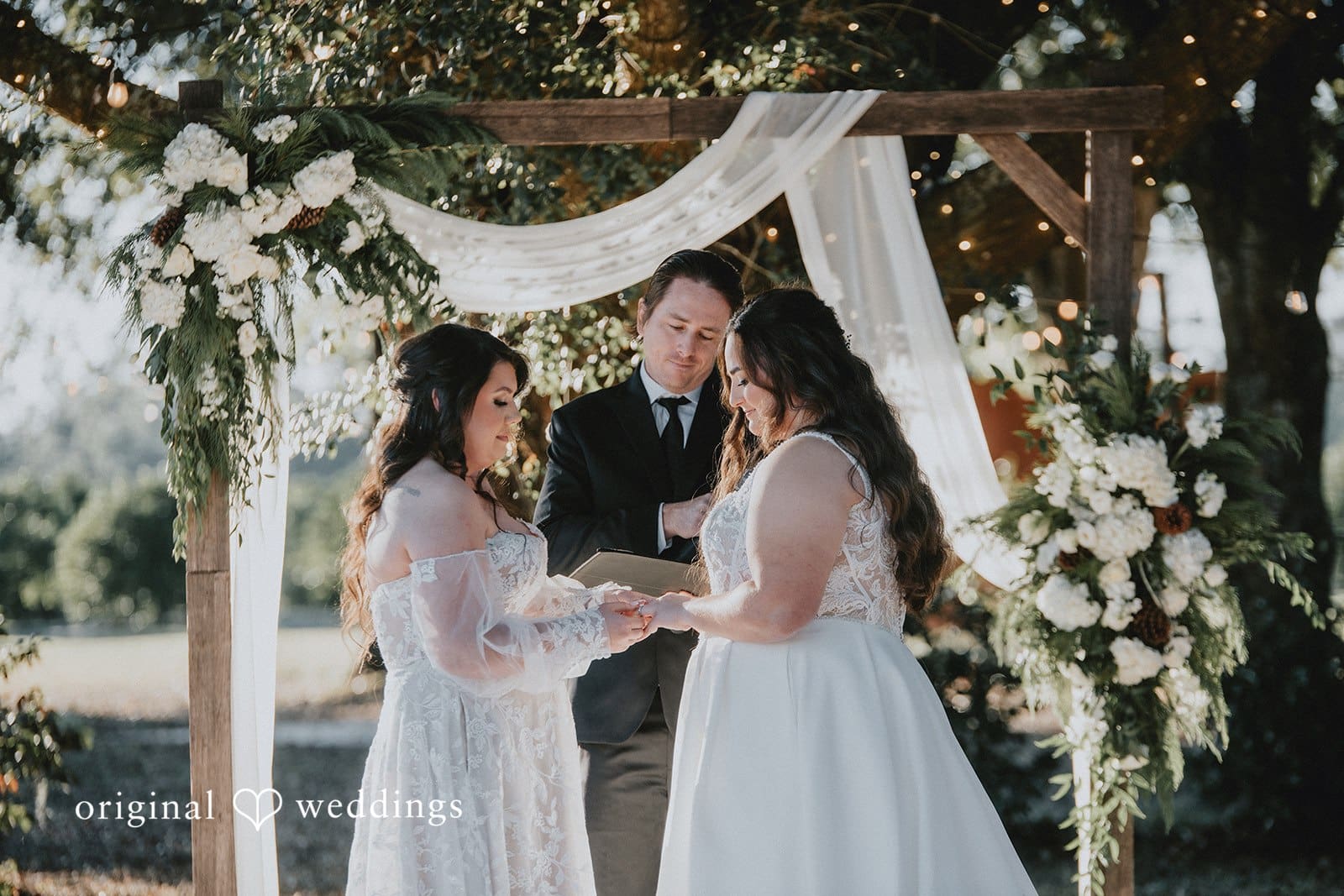 The couple exchanging rings at their Ever After Farms Citrus wedding ceremony
