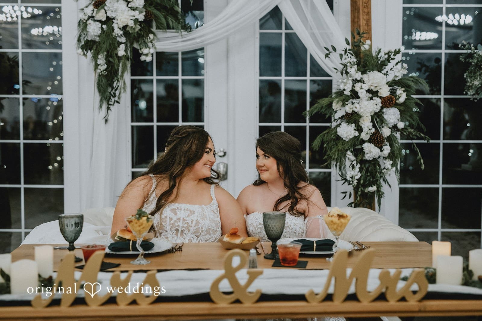A portrait of the couple seated at their wedding reception