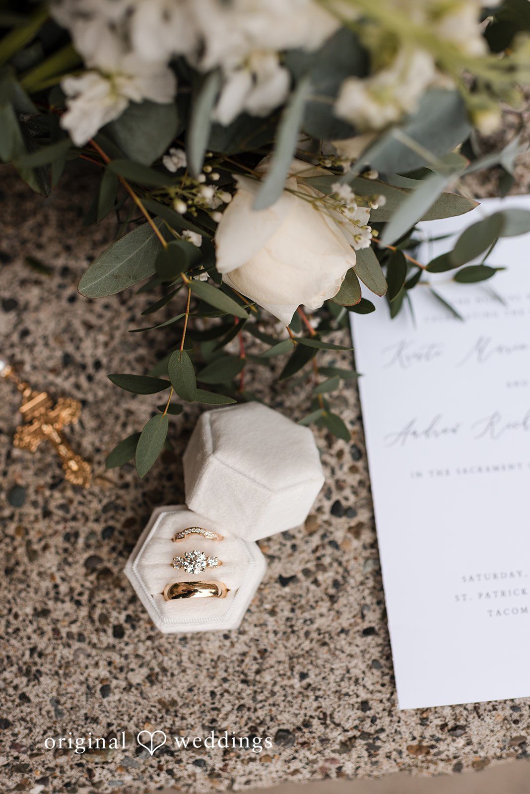 Kristi + Andrew Close-up of bride and groom wedding rings with soft lighting