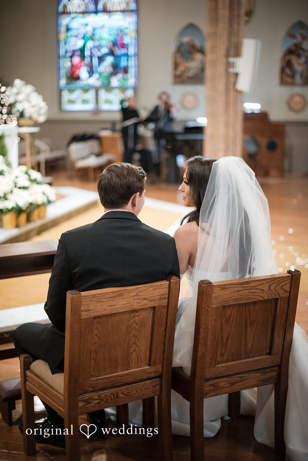 Kristi + Andrew Bride and groom sitting together during ceremony at Foss Waterway Seaport captured by Seattle wedding photographer from Original Weddings