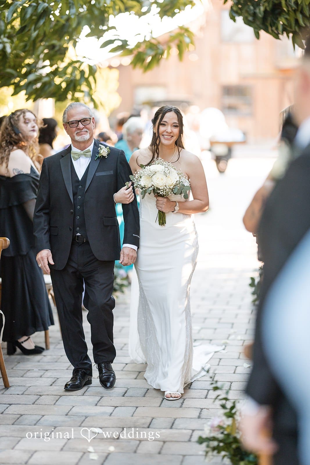 Bride with man on aisle at Hacienda Los Robles.