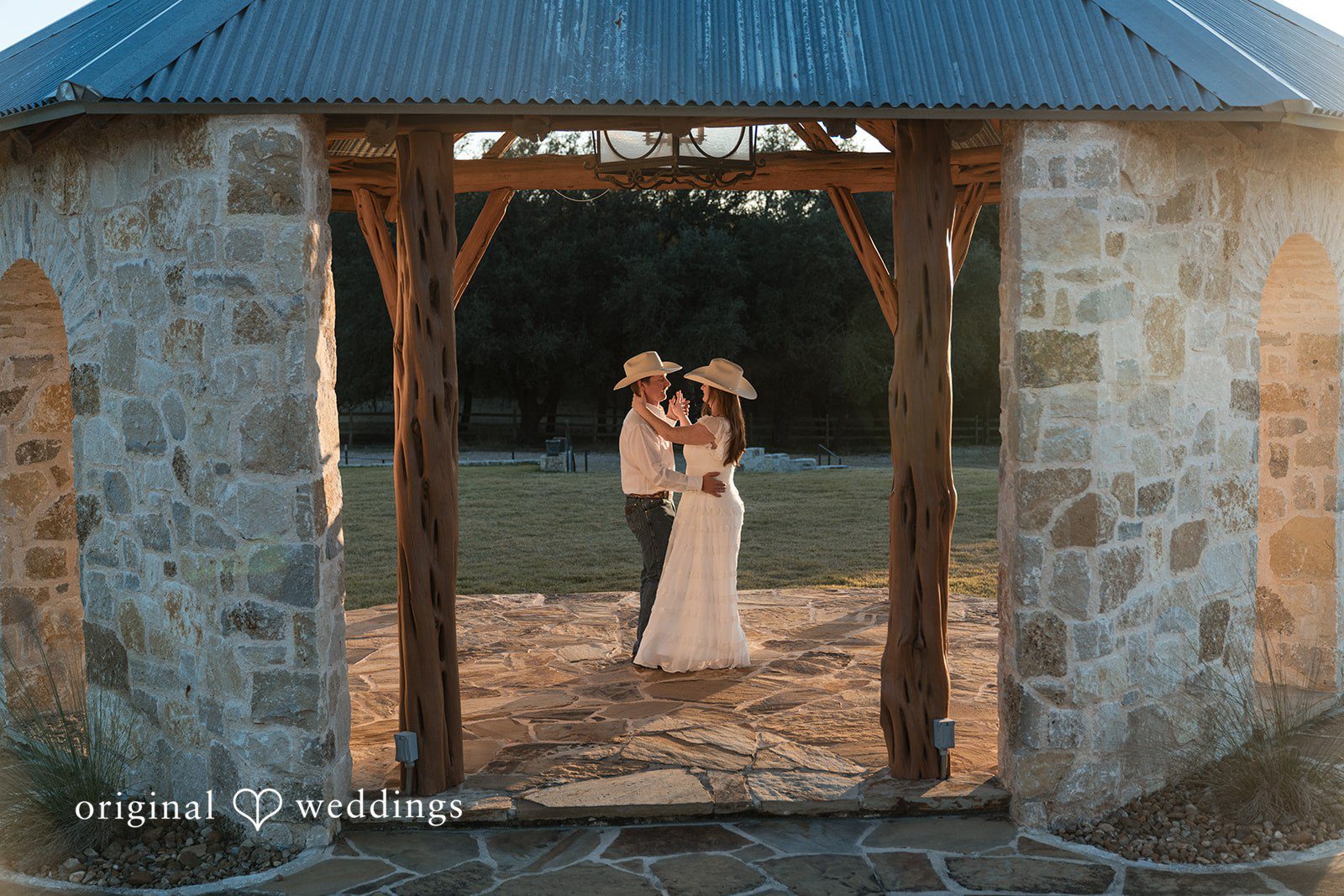 Framed by stone architecture, they stand together in a timeless embrace.