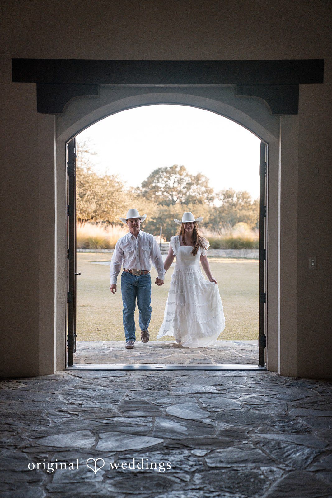 Walking together into a new chapter, framed by natural light and architecture.
