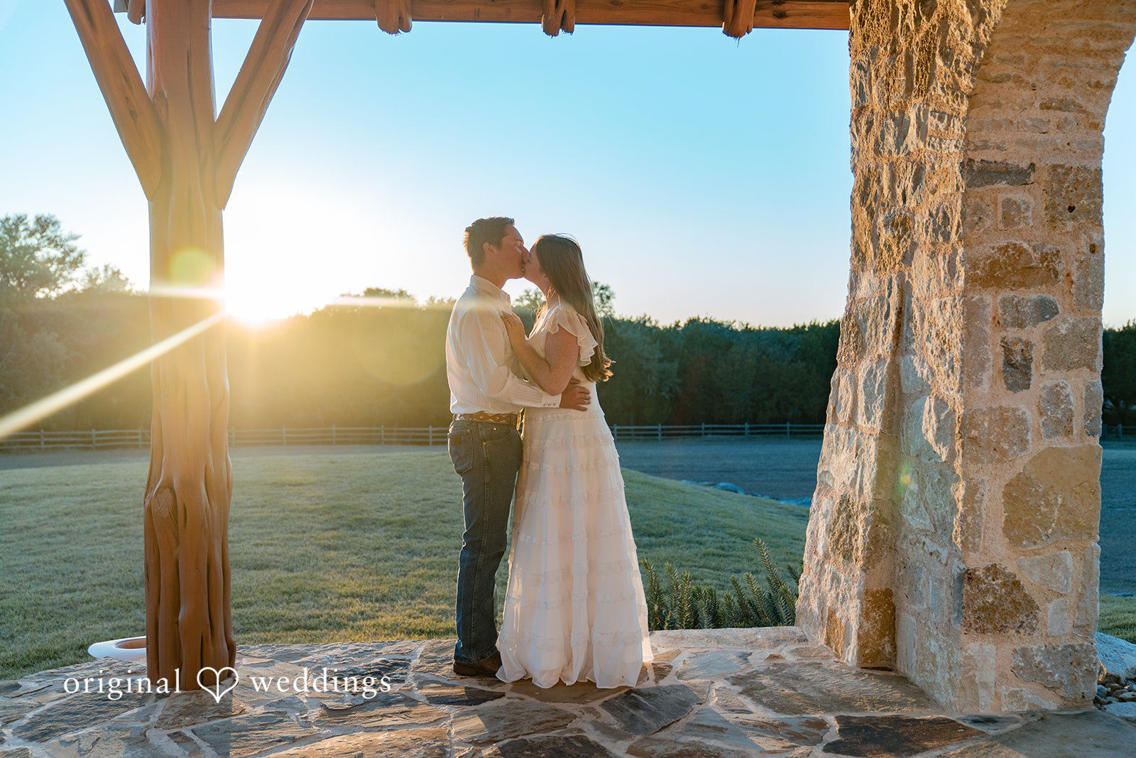 A golden sunset frames the couple in a deeply romantic silhouette.
