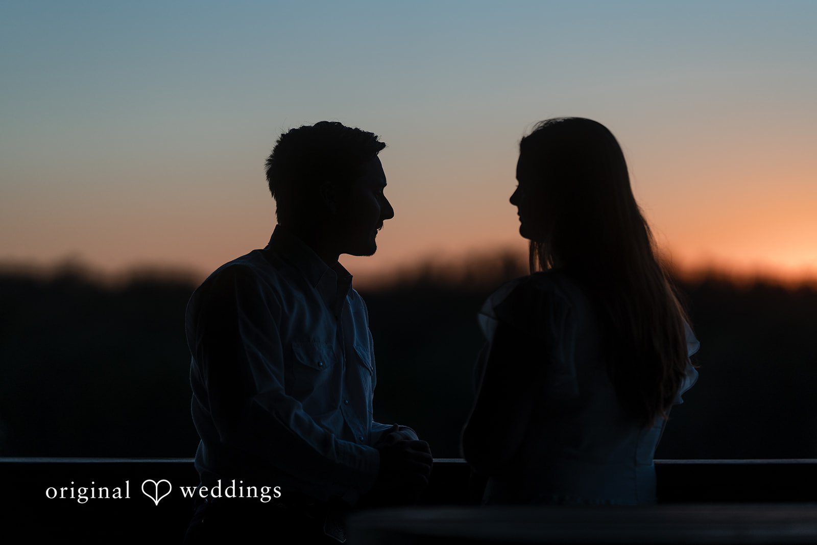 Silhouetted against a colorful sky, their love stands out beautifully, a moment often captured by austin wedding photographers.