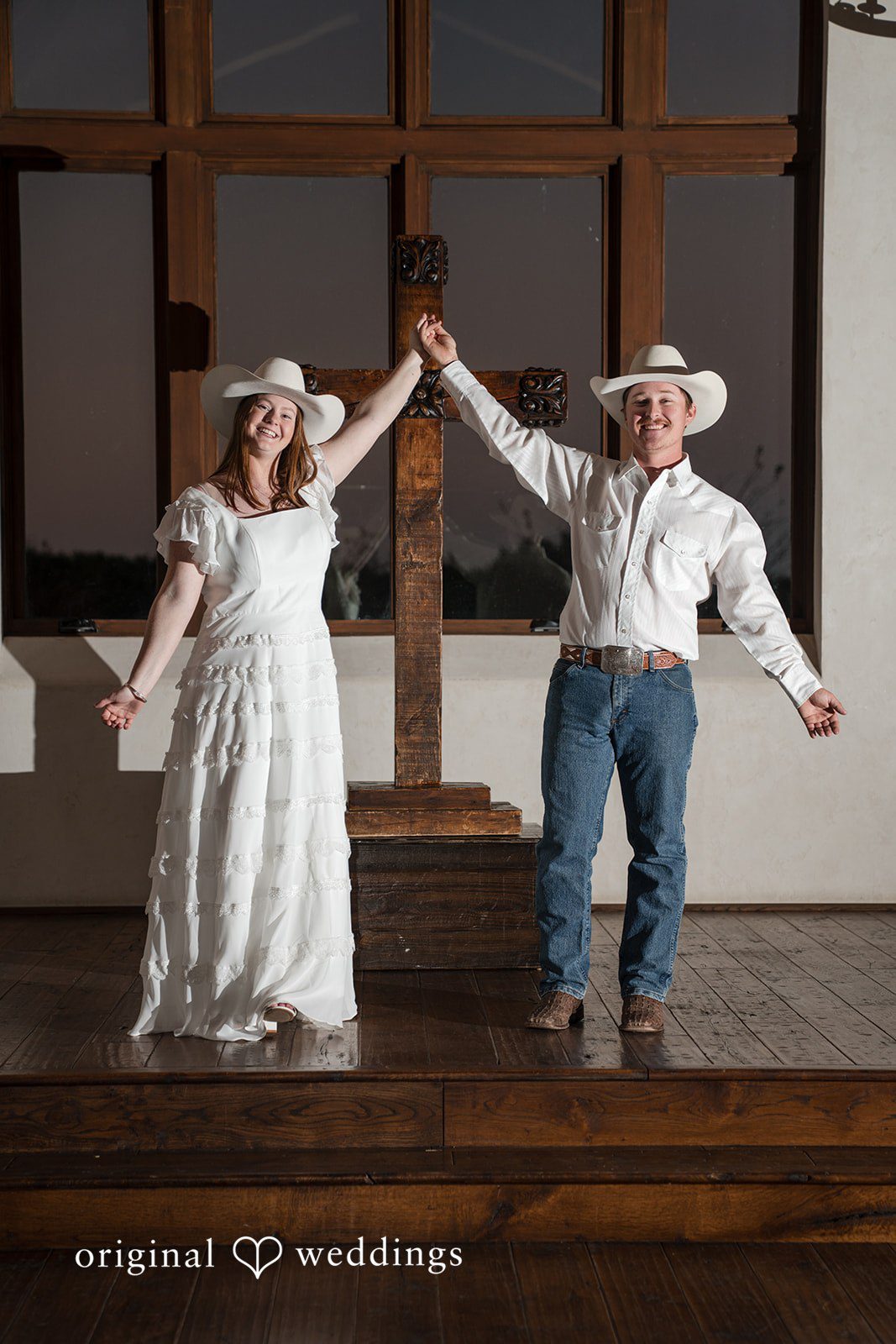Hand in hand, they celebrate their love with playful energy indoors.