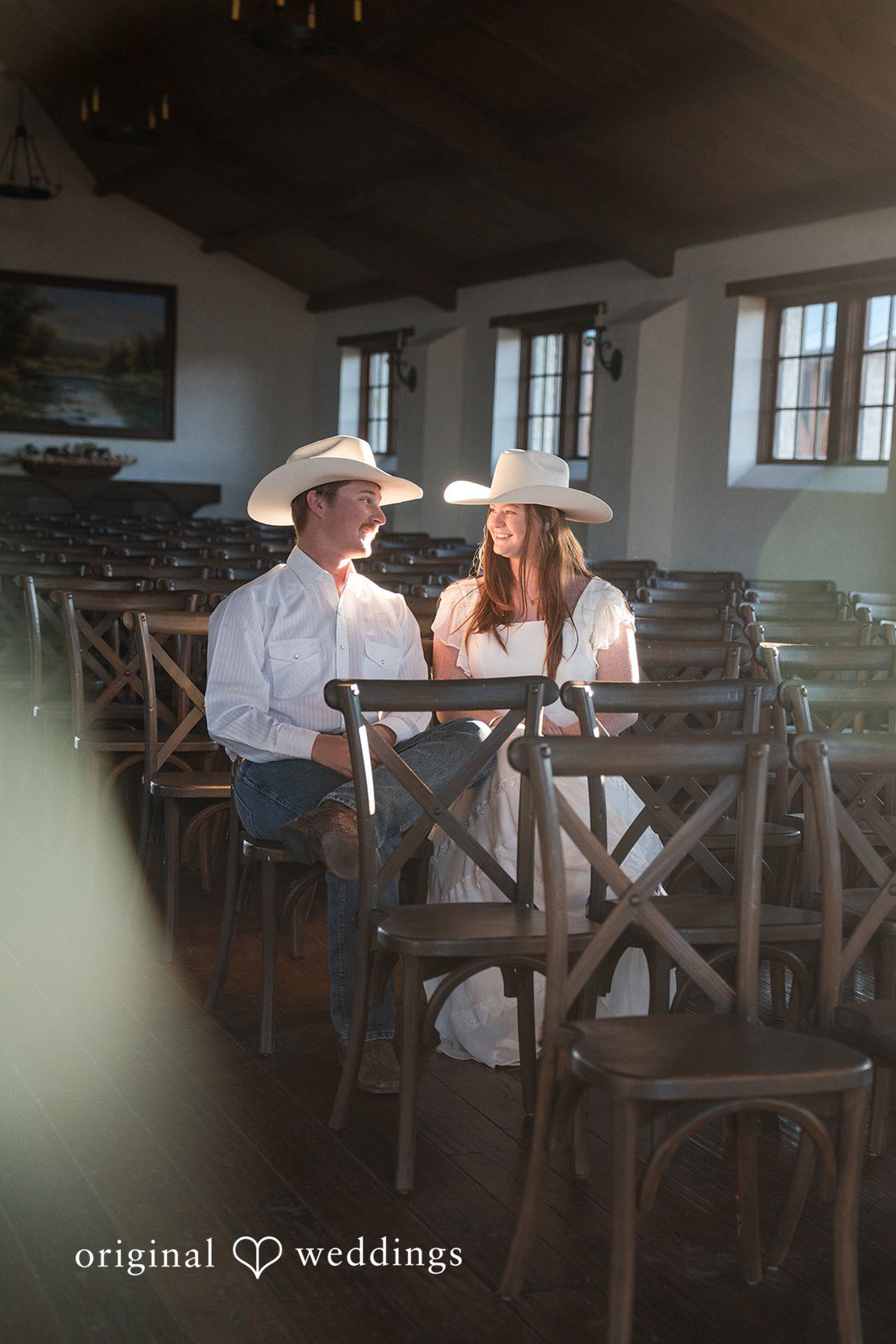 Sitting together indoors, they share a relaxed and intimate conversation.