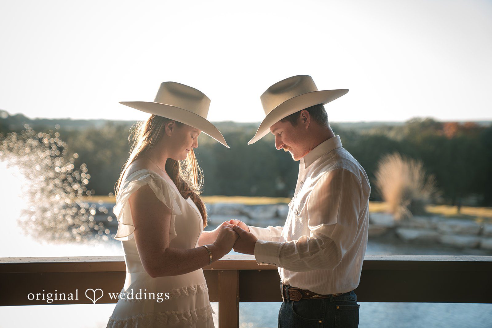 Holding hands by the water, they reflect calm and connection.