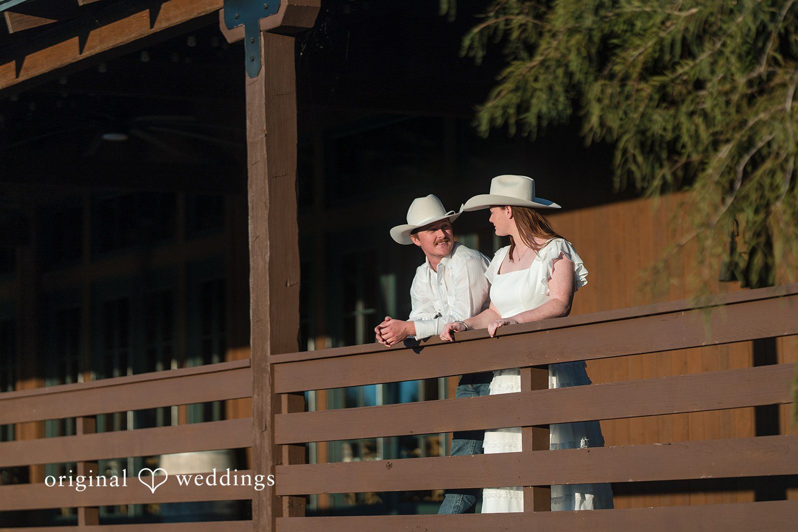 Sharing a quiet moment on a balcony, they enjoy each other’s presence.