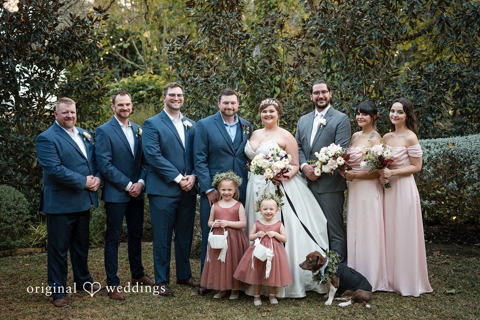 Our Austin wedding photographers at Original Weddings captured a portrait of the couple, their pup, and their bridal party at Hummingbird House