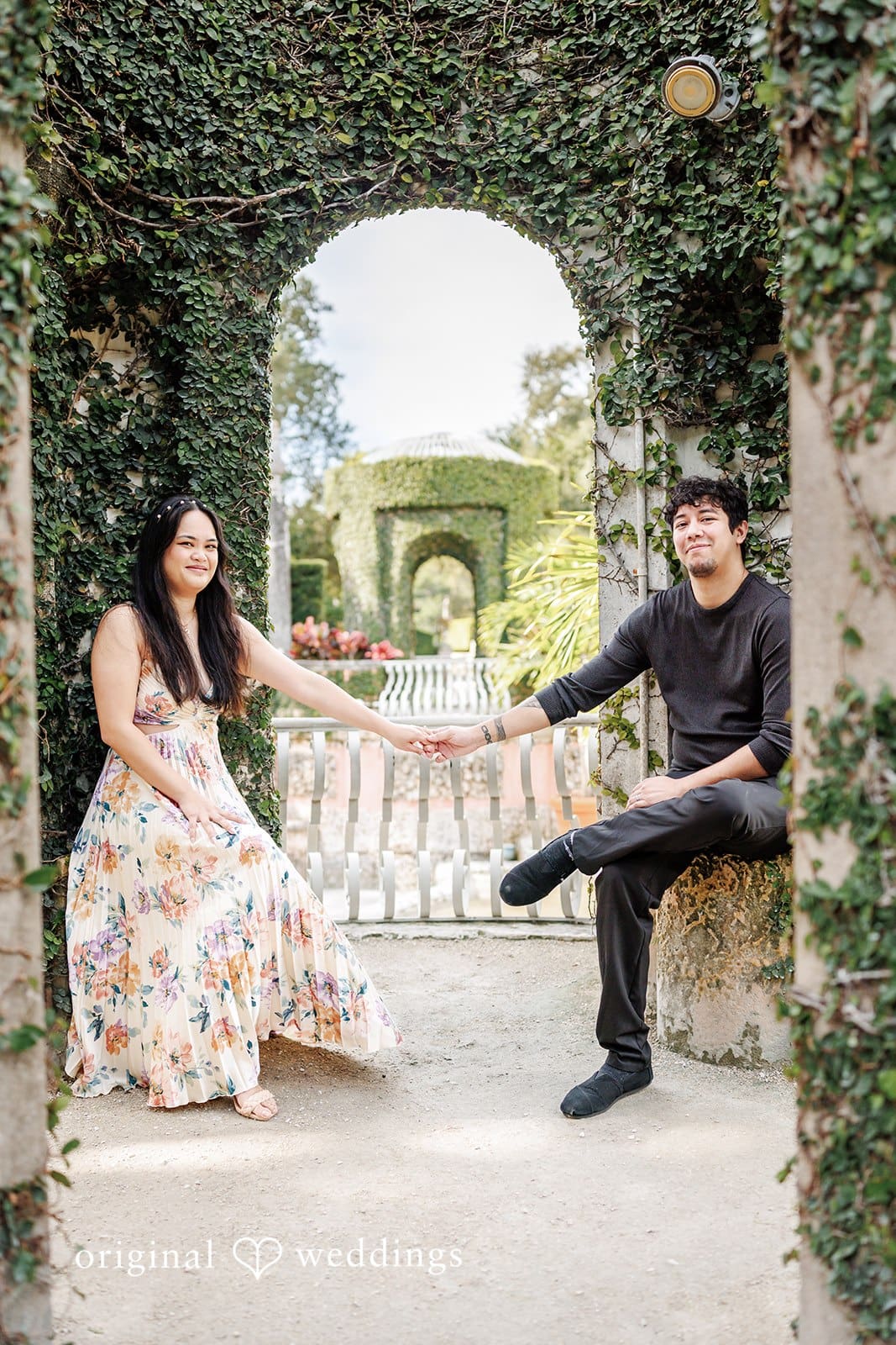 Kristian + Fernando Close-up of couple seated, holding hands at Vizcaya Museum & Gardens
