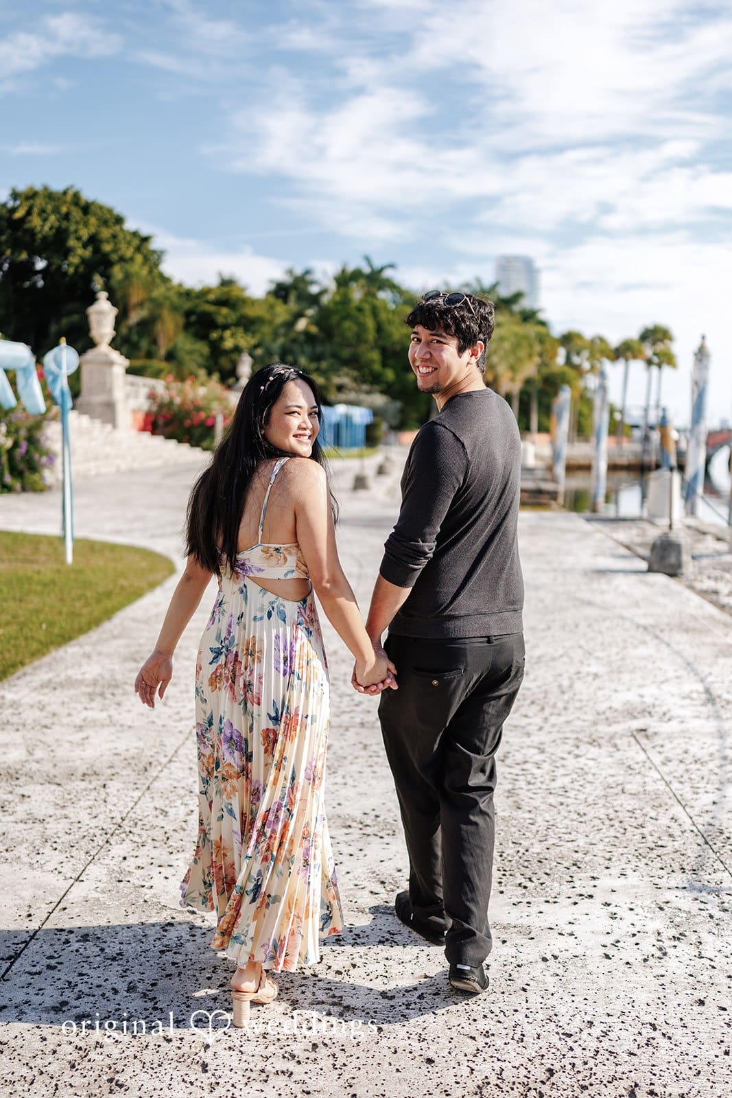Kristian + Fernando Romantic engagement photo of couple walking hand-in-hand at Vizcaya Museum & Gardens