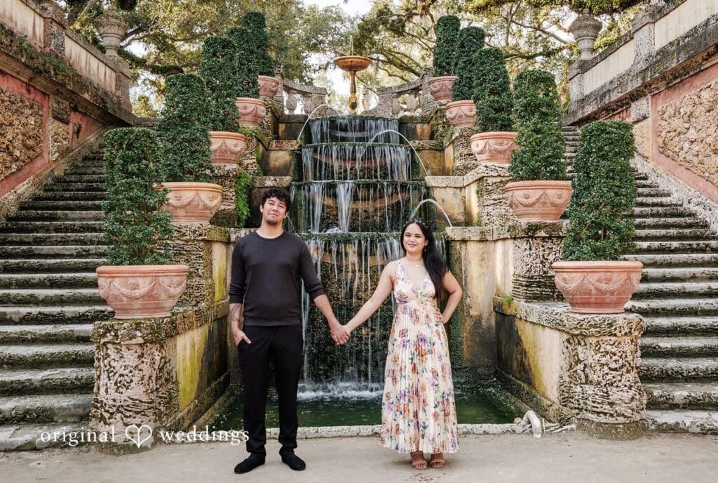 Kristian + Fernando Miami Engagement Photographer capturing close-up of couple couple hand-in-hand with serene water backdrop at Vizcaya Museum & Gardens by Original Weddings