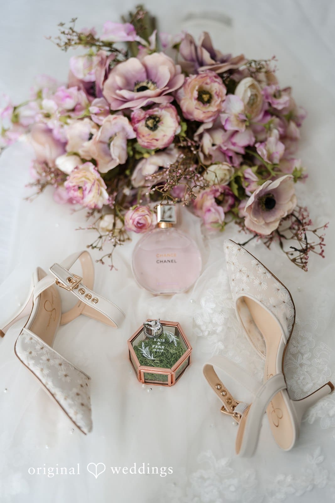 Wedding flat lay with flowers, rings, and accessories.