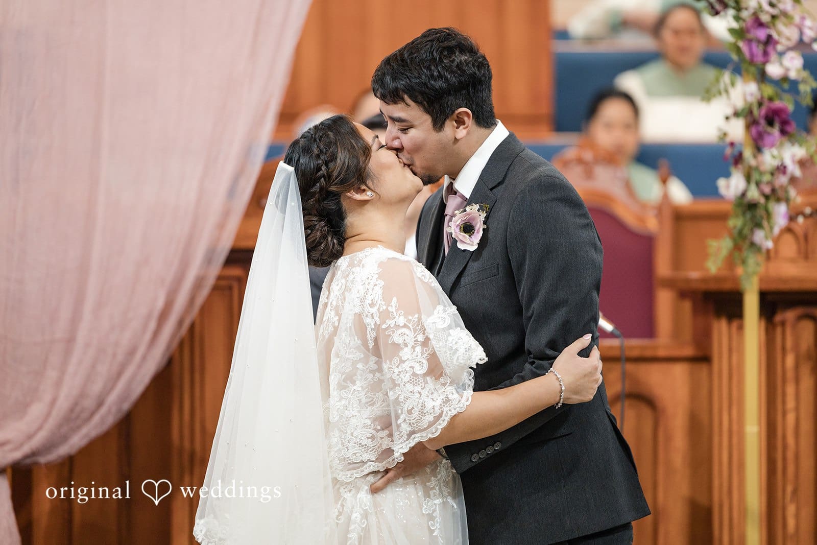 Bride and groom kissing at wedding ceremony at Iglesia Ni Cristo