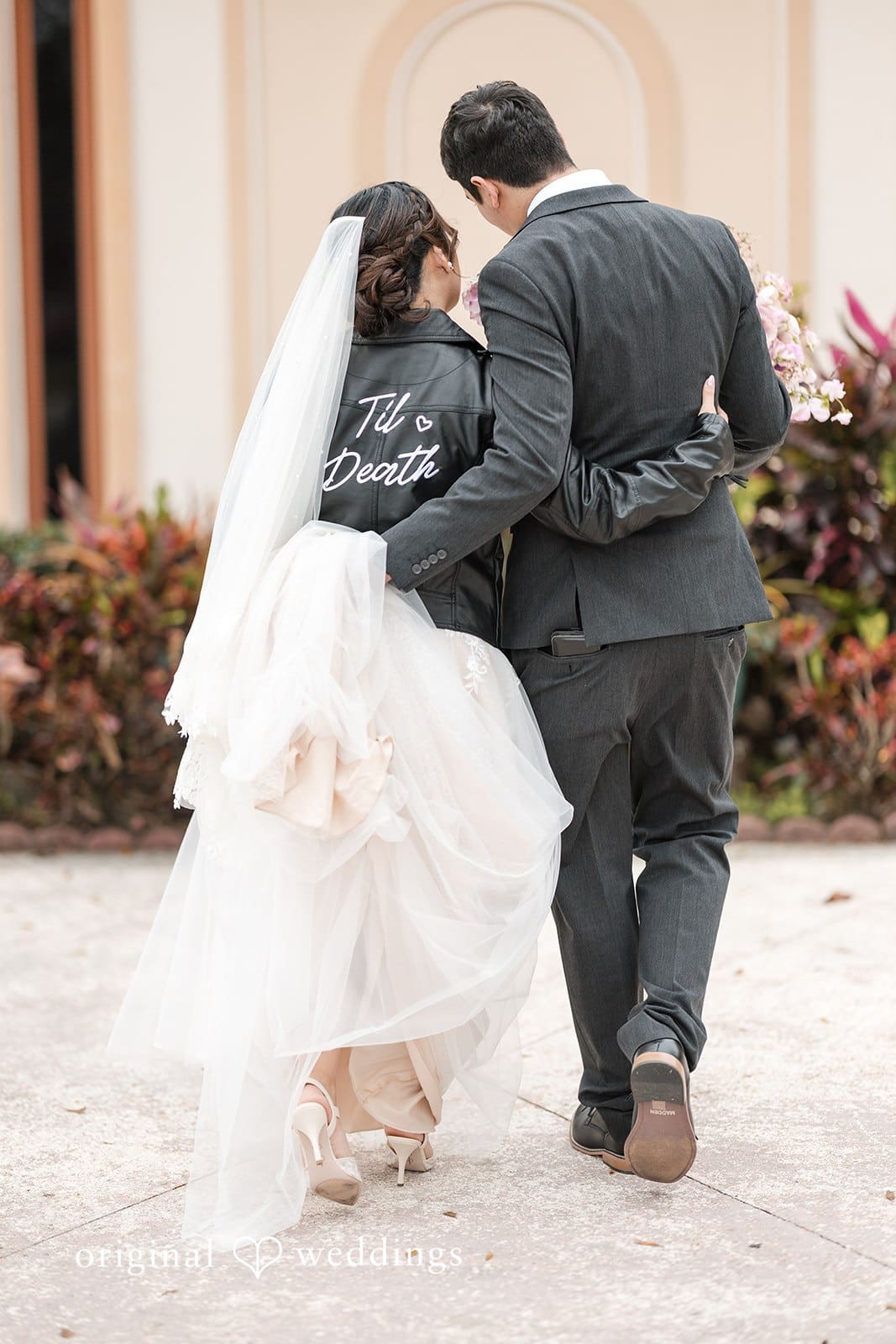 Groom lifting bride's gown