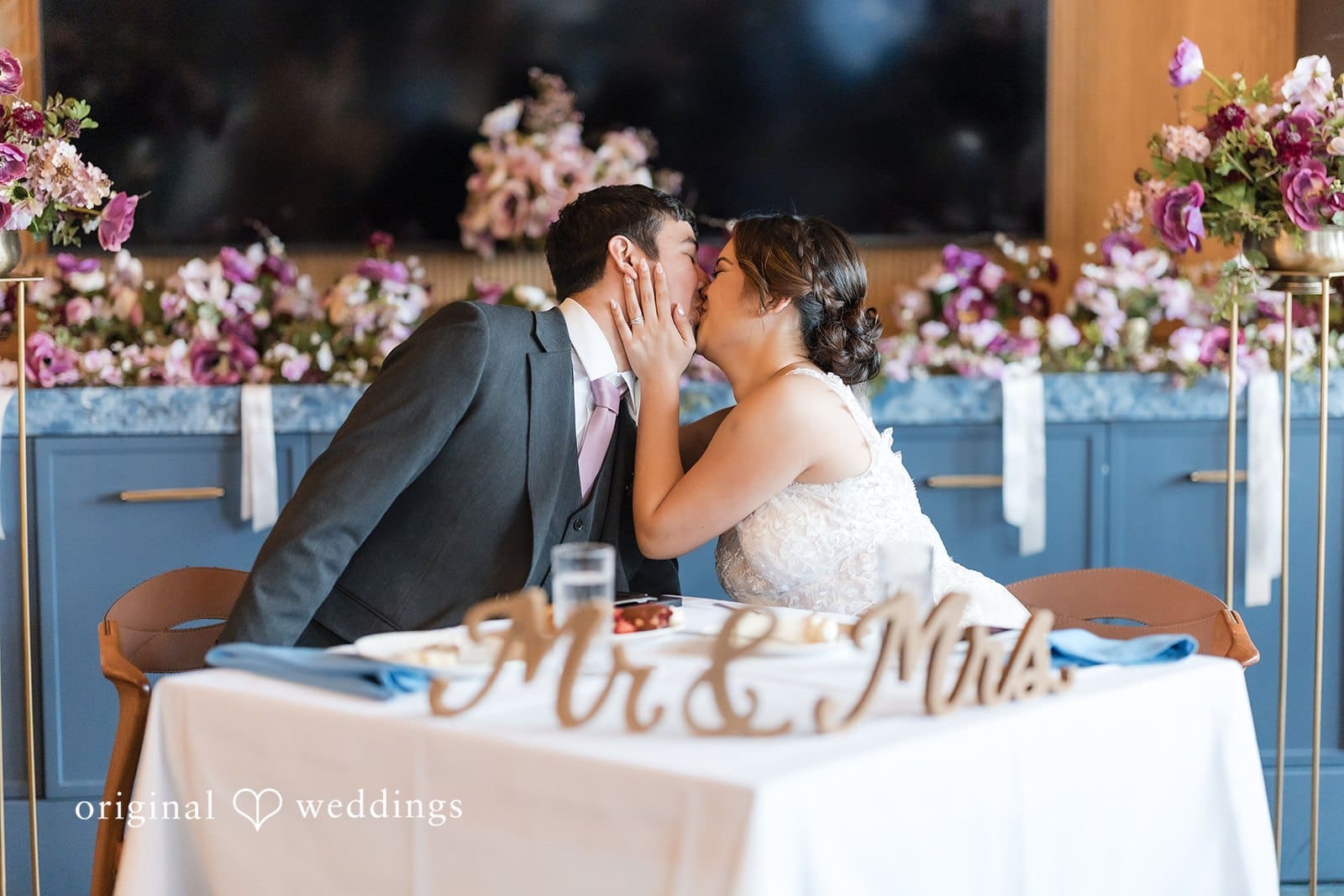 Bride and Groom celebrating at a reception table with champagne.