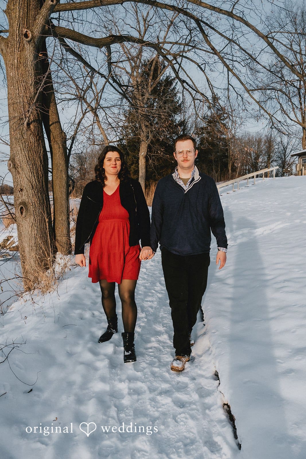 The couple takes a walk through the snowy environment