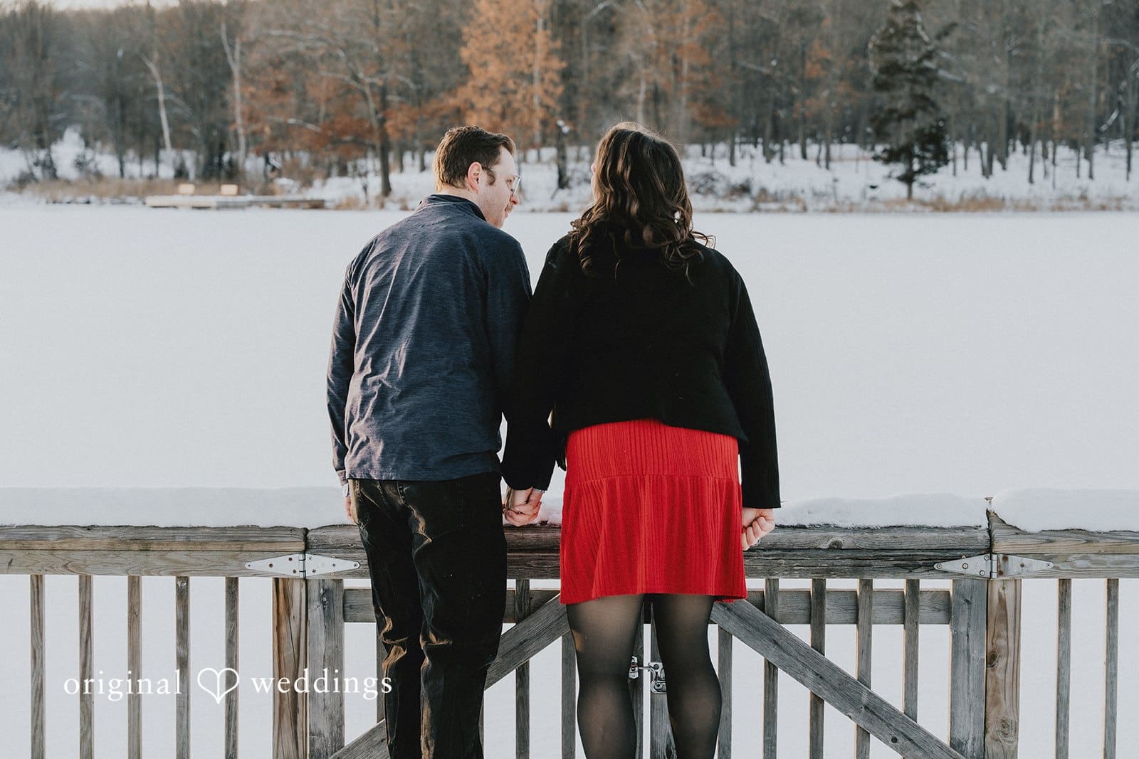 A portrait of the couple looking at the water