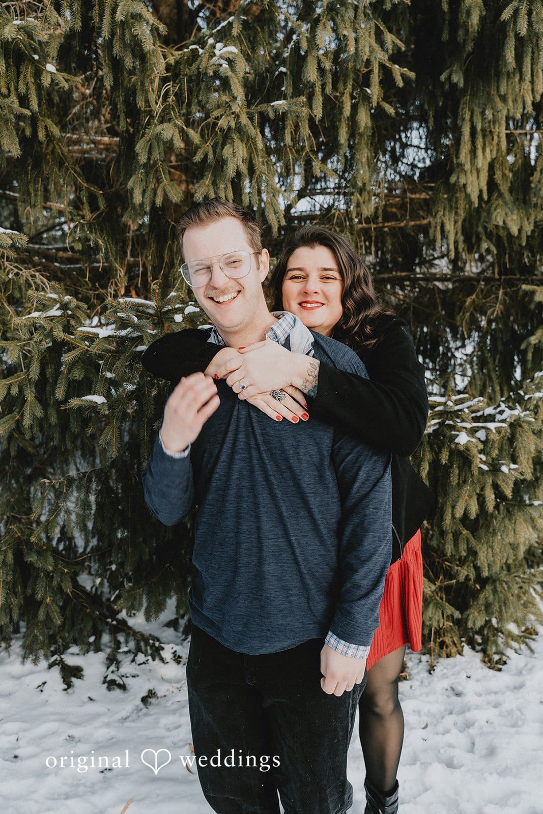 A romantic portrait of the couple in the snowy environment of Independence Oaks