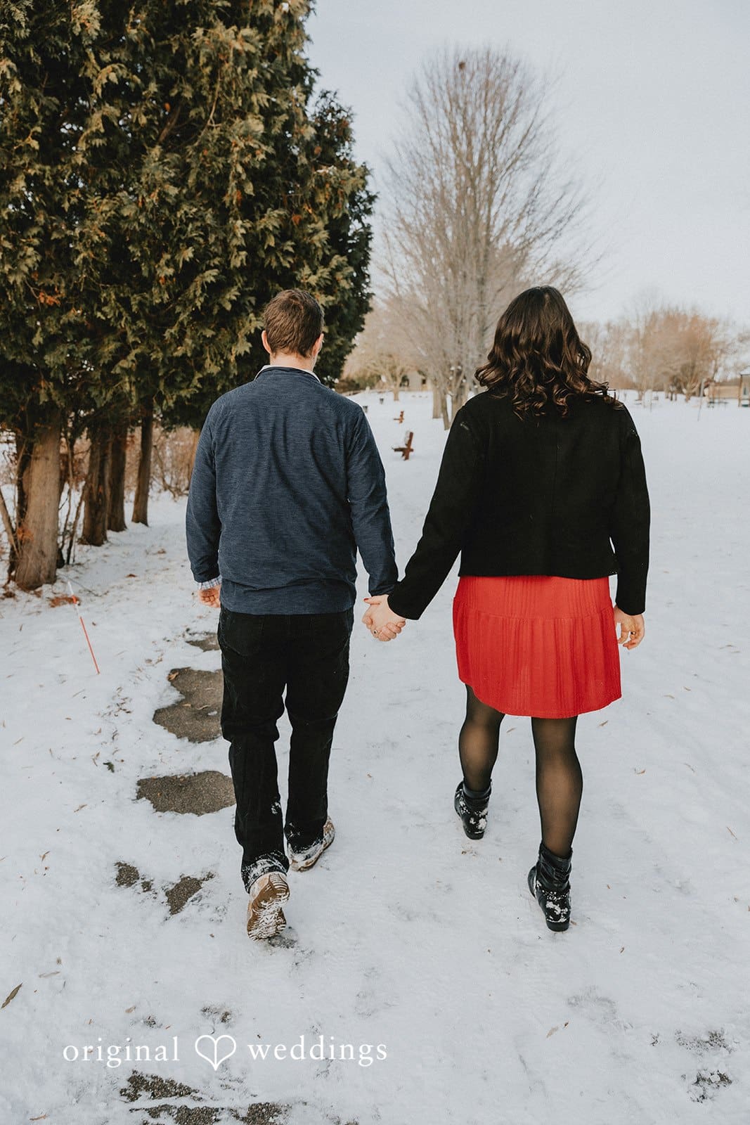 The couple taking a walk through the snowy environment of Independence Oaks