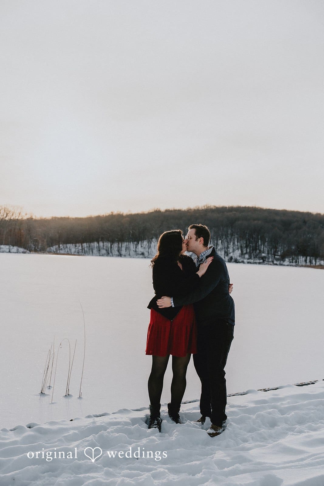 The couple shares a kiss at the waterfront