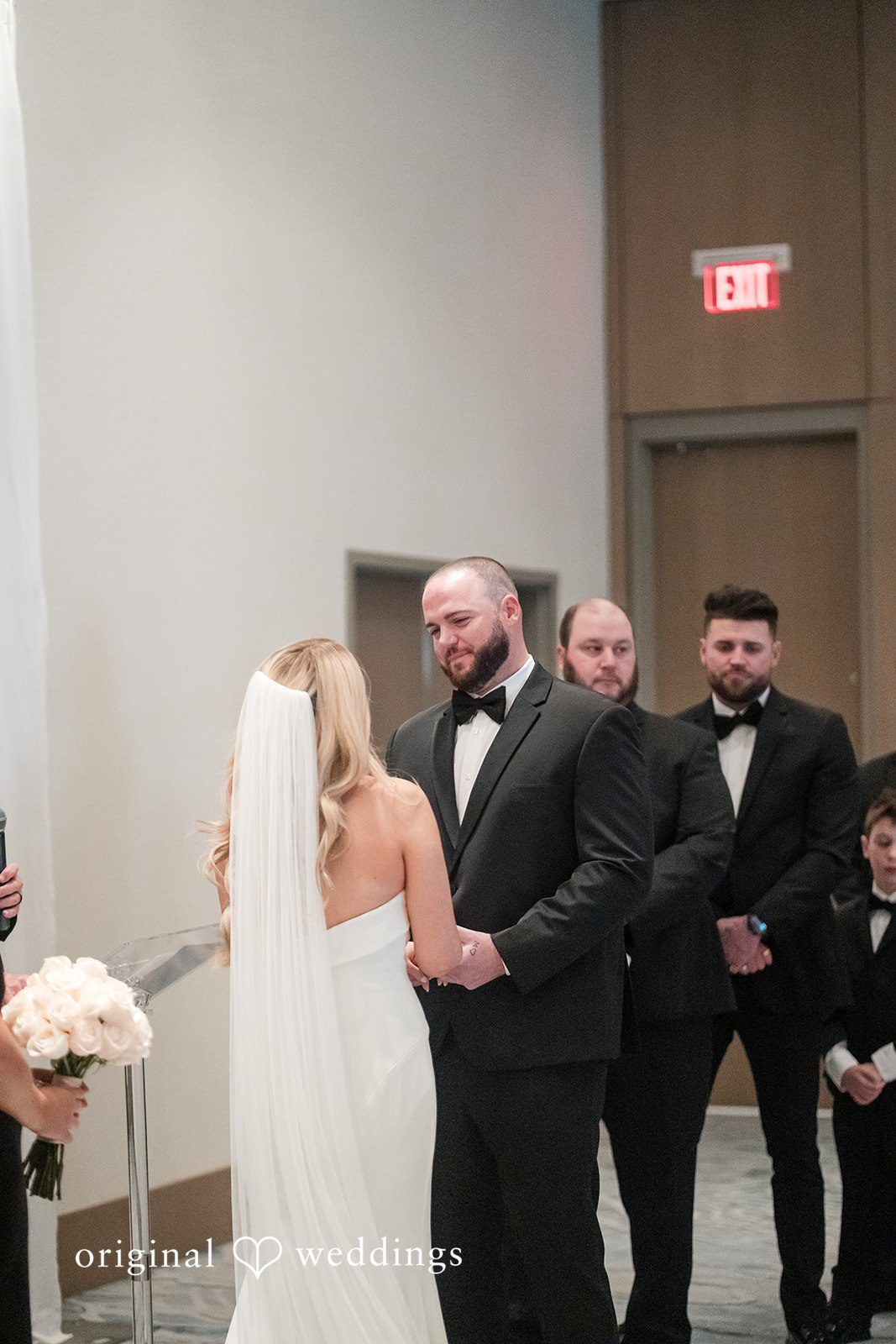 Couple holding hands during during ceremony.