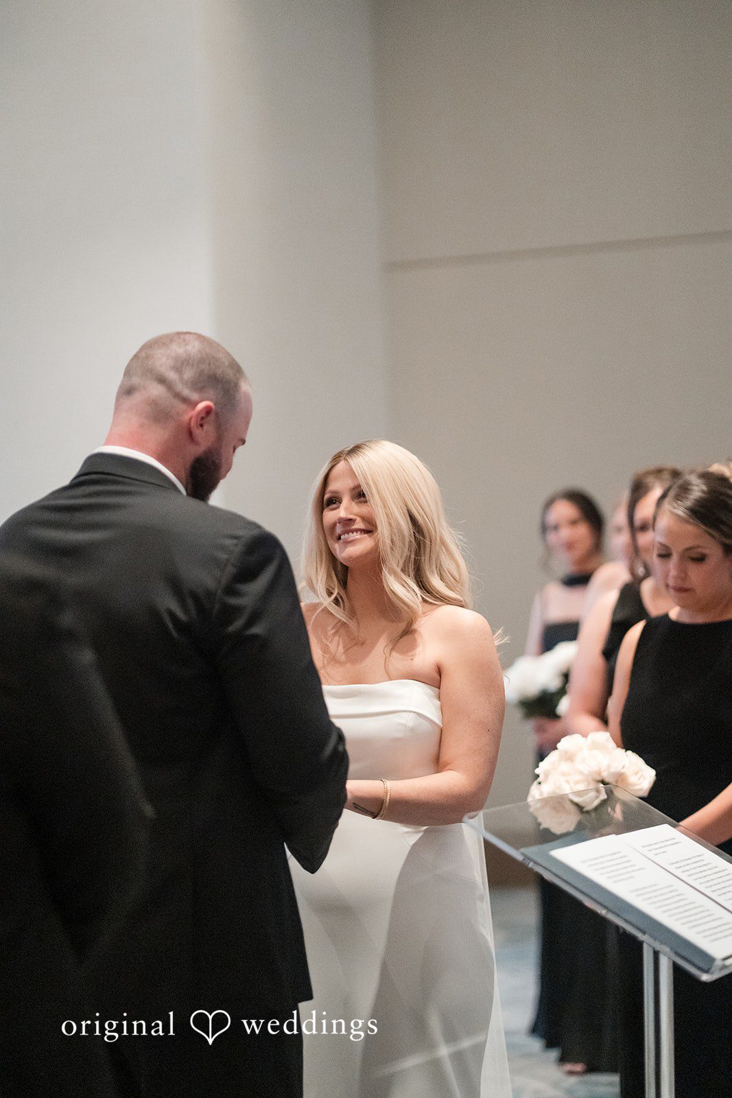 Bride and groom exchanging vows during ceremony.