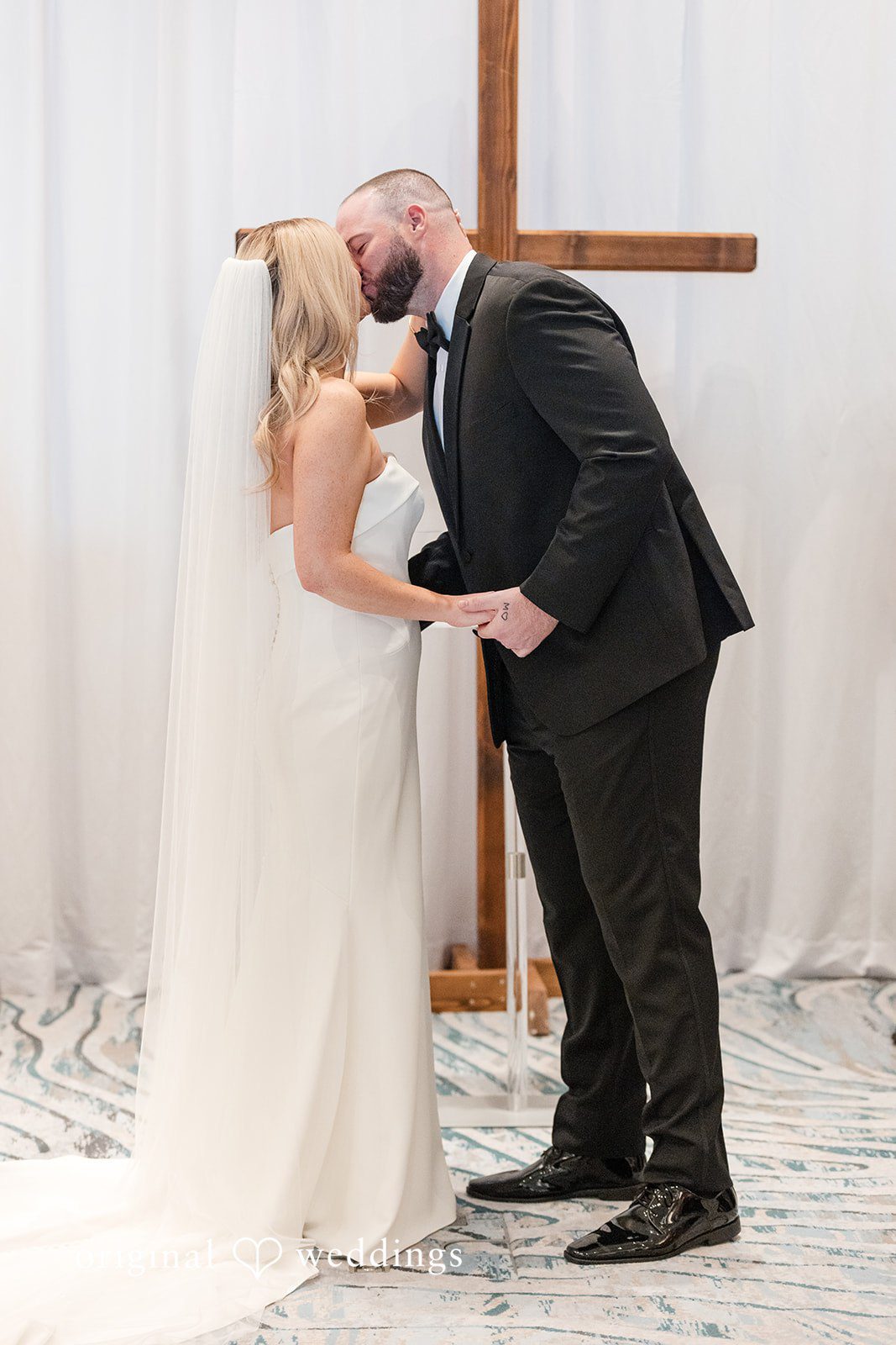Groom kissing bride during ceremony at JW Marriott Clearwater Beach Resort.