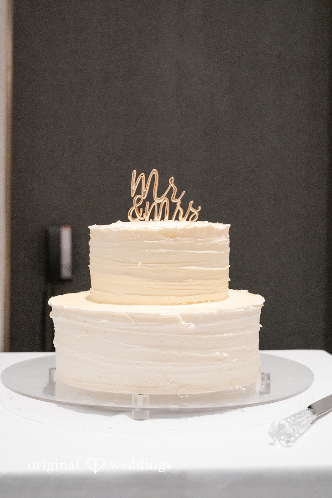 Multi-layer white wedding cake on a table.