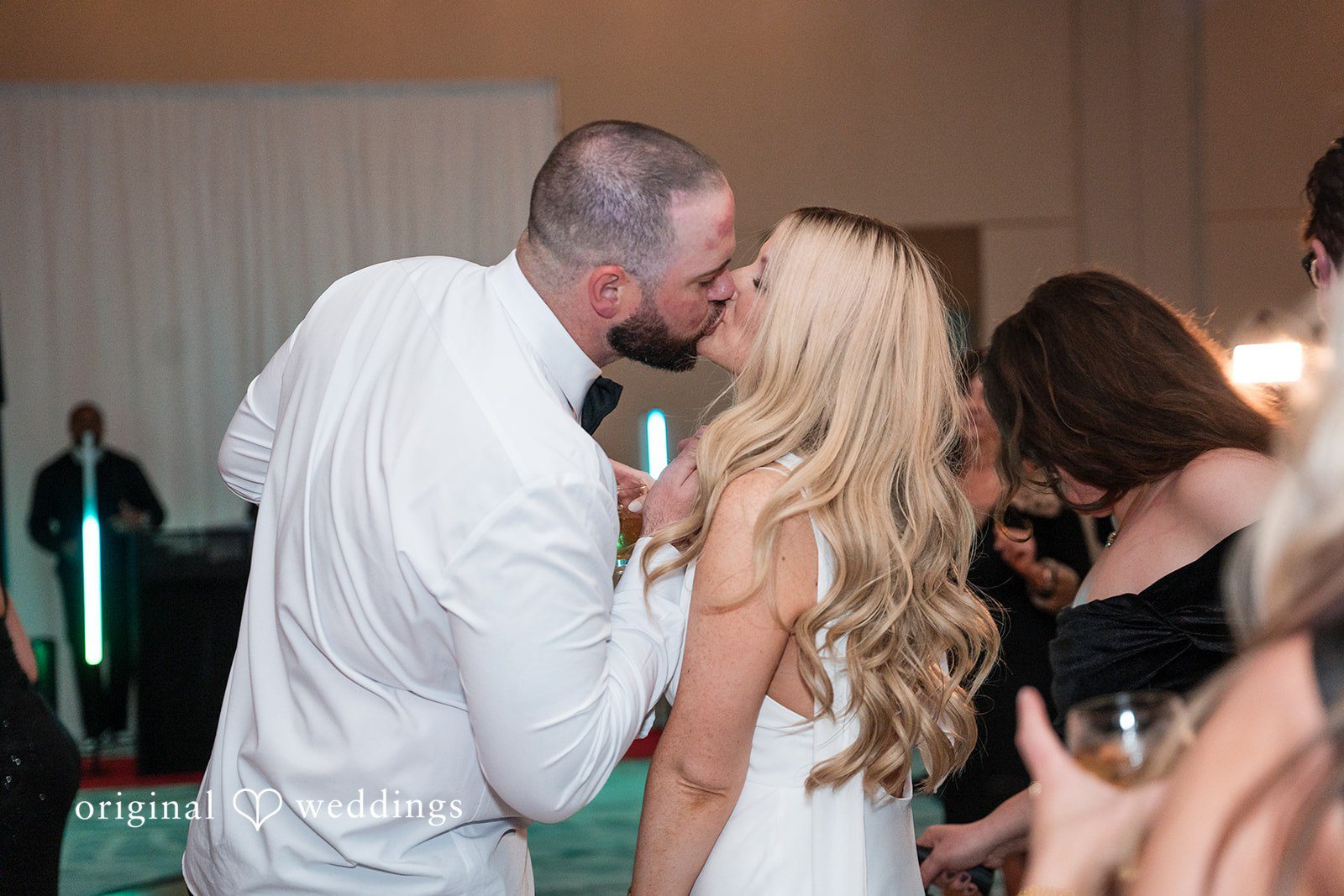 Dancing couple sharing a romantic kiss.