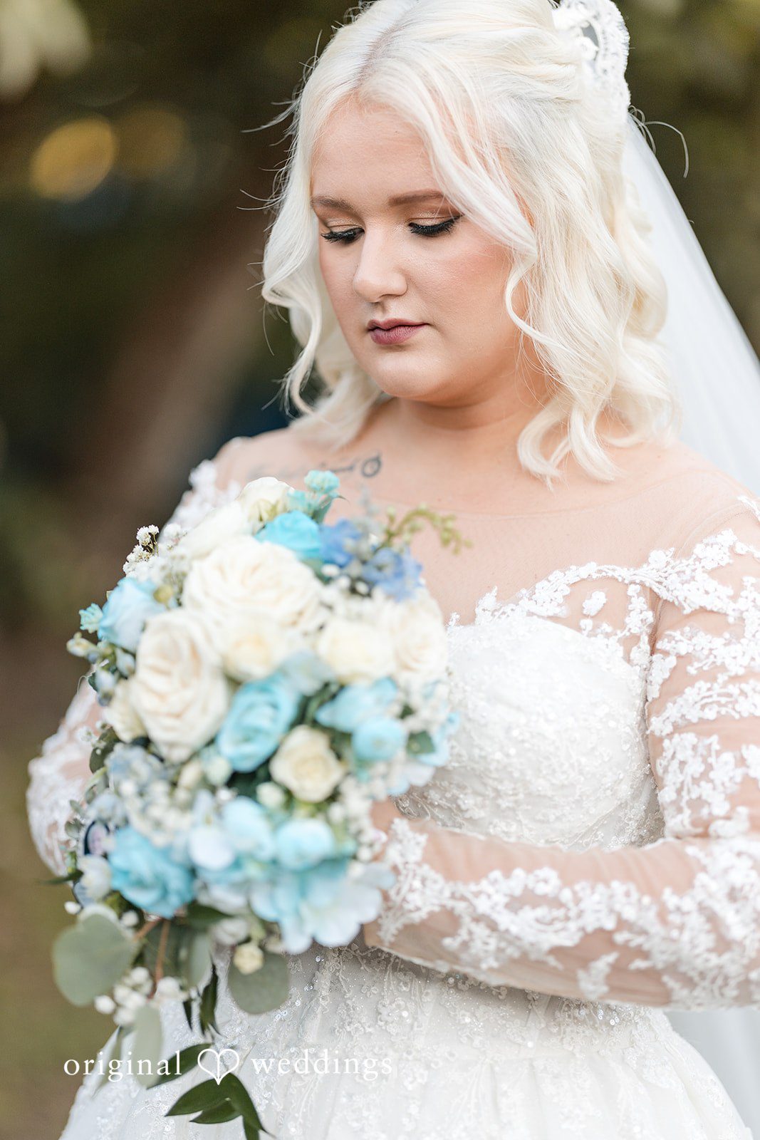 Beautiful bride holding bouquet and posing after getting ready at Lovely Barn