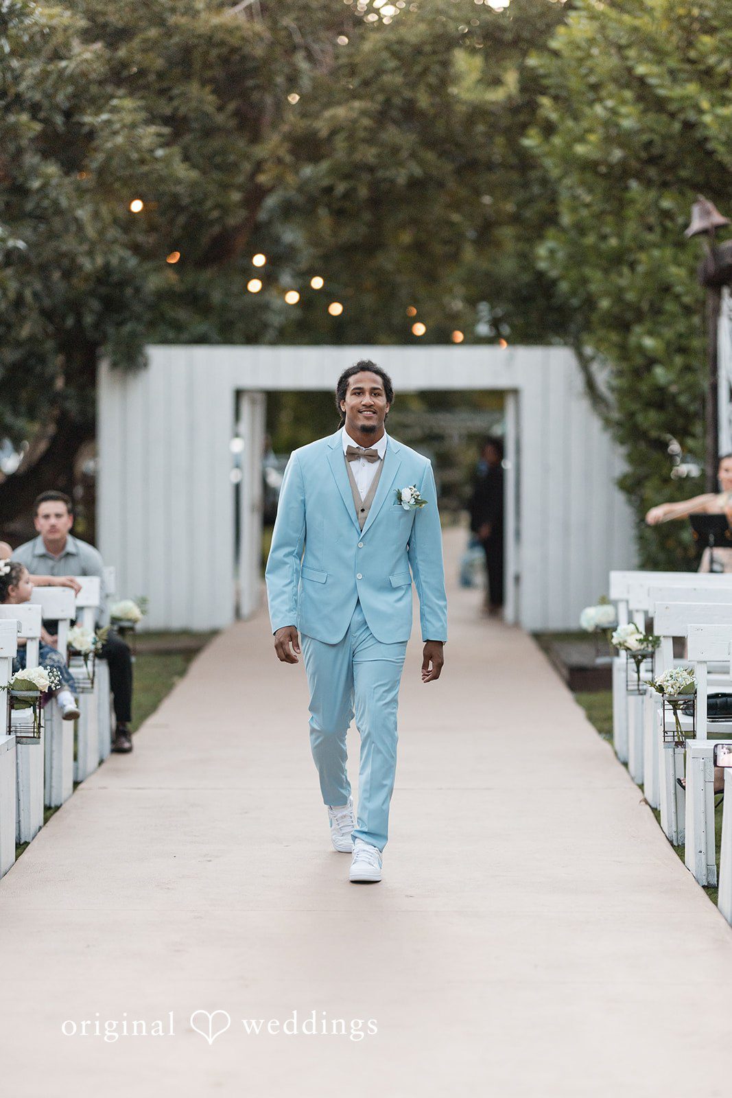 Original Weddings capturing stylish groom entry at Lovely Barn