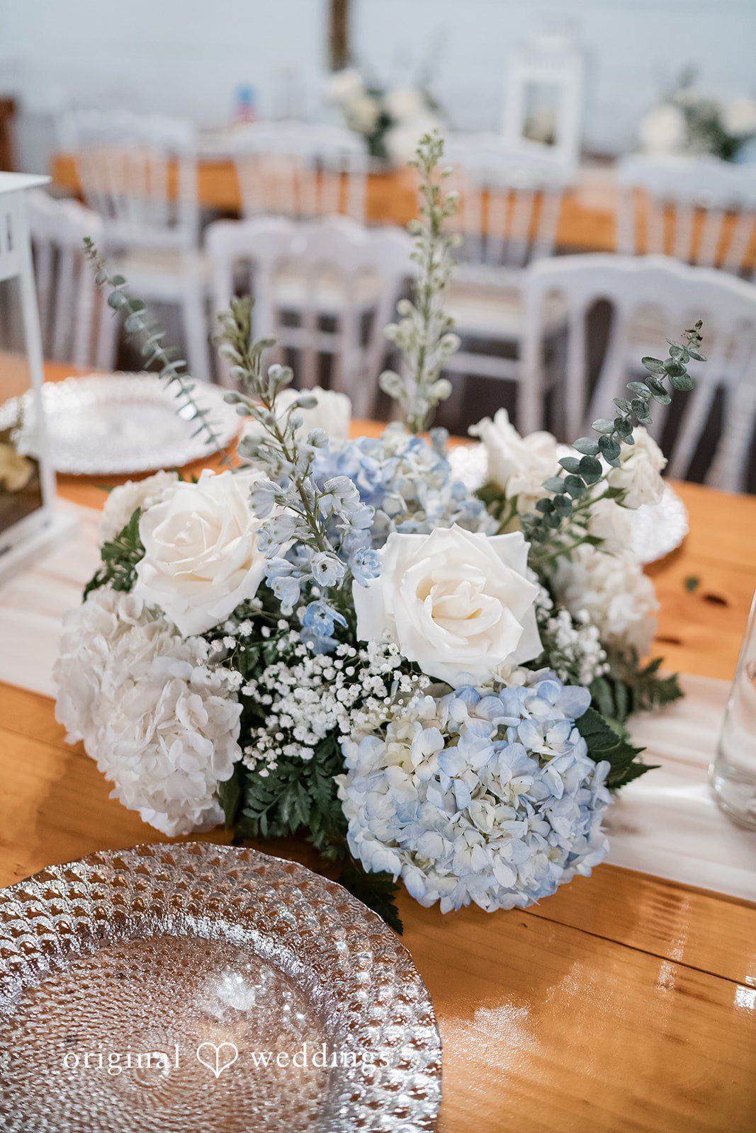Close-up of reception food table with floral decor at Lovely Barn